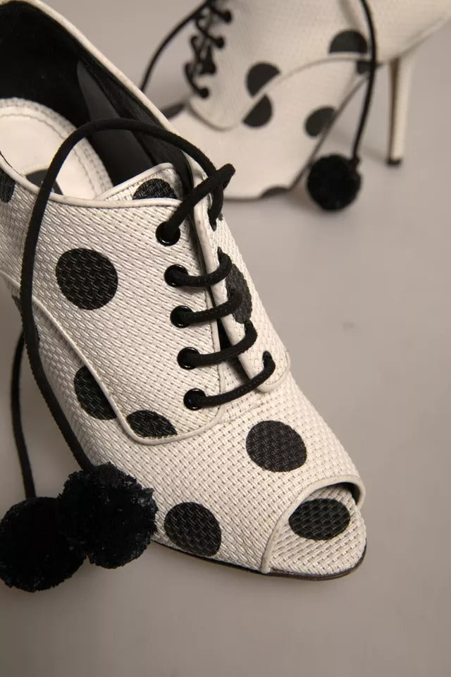 Step into refined elegance with Dolce & Gabbana's White Black Polka Dot Peep Toe Ankle Boots, where luxurious leather and playful design elevate your style to new heights.