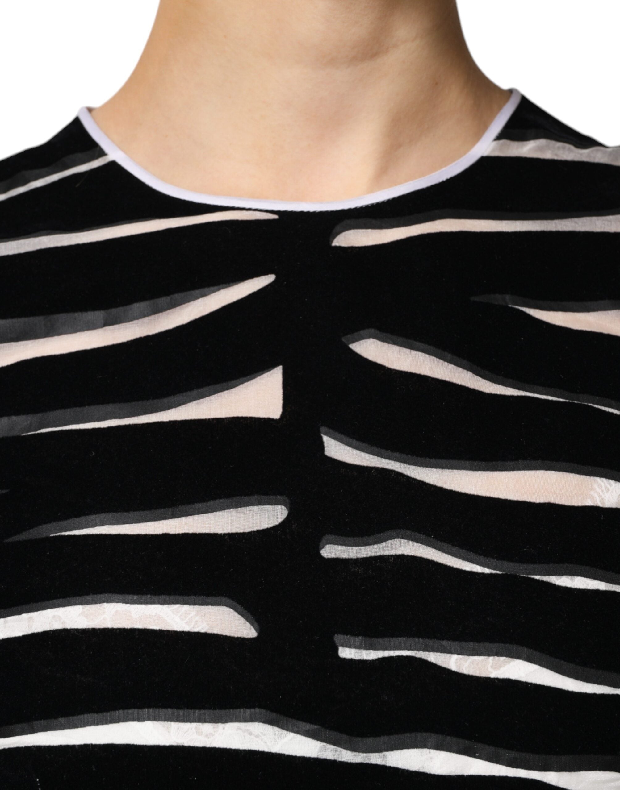 Elevate your wardrobe with the Dolce & Gabbana Black White Zebra A-line Sheath Mini Dress, a masterpiece of silk and nylon that embodies timeless elegance and exquisite craftsmanship.