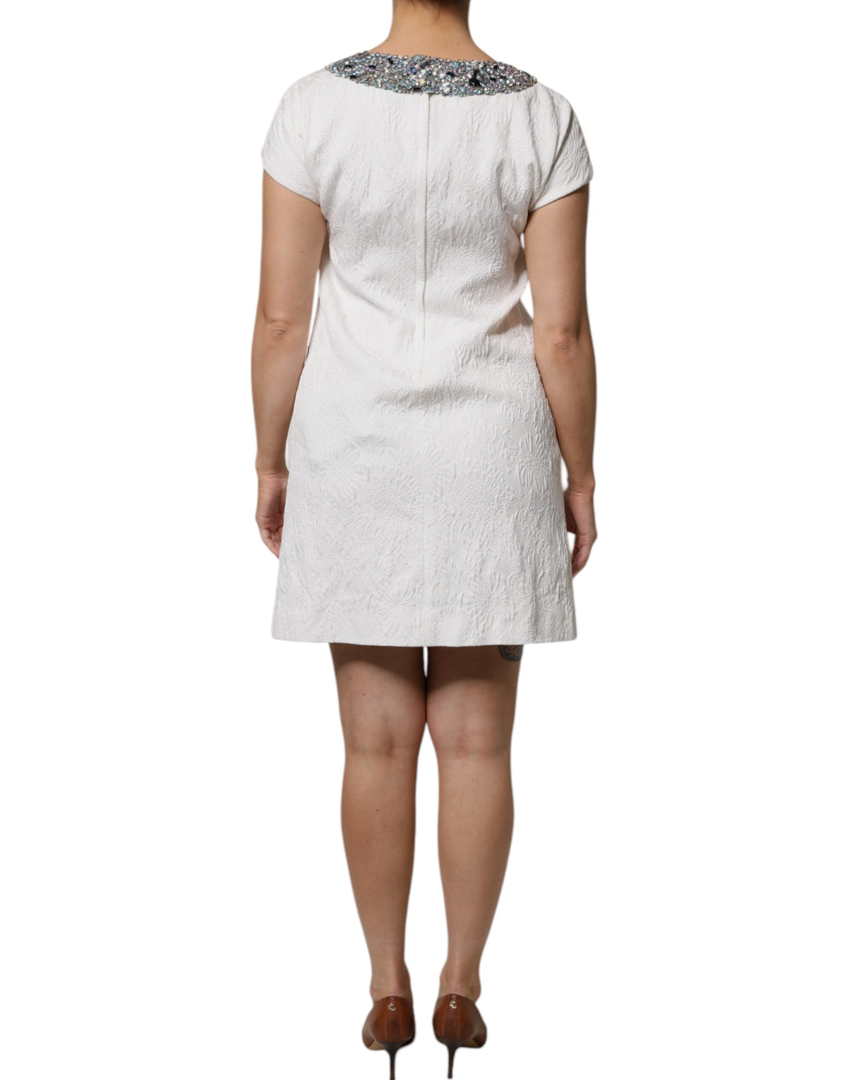 Indulge in the exquisite Dolce & Gabbana White Crystal Embellished Jacquard Brocade Mini Dress, a timeless masterpiece that embodies elegance and sophistication for unforgettable moments.