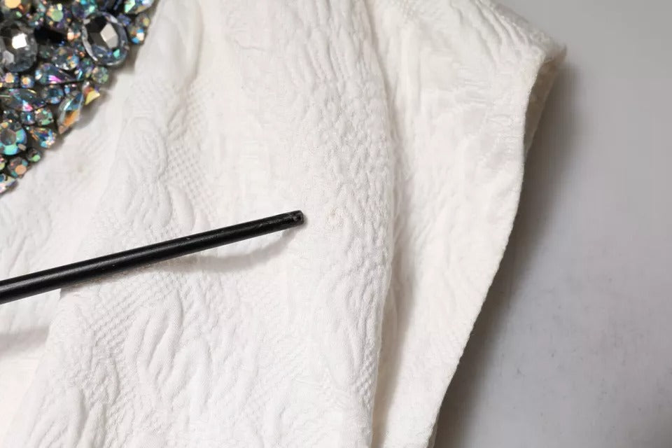 Indulge in the exquisite Dolce & Gabbana White Crystal Embellished Jacquard Brocade Mini Dress, a masterpiece of Italian craftsmanship that embodies timeless elegance and sophistication.