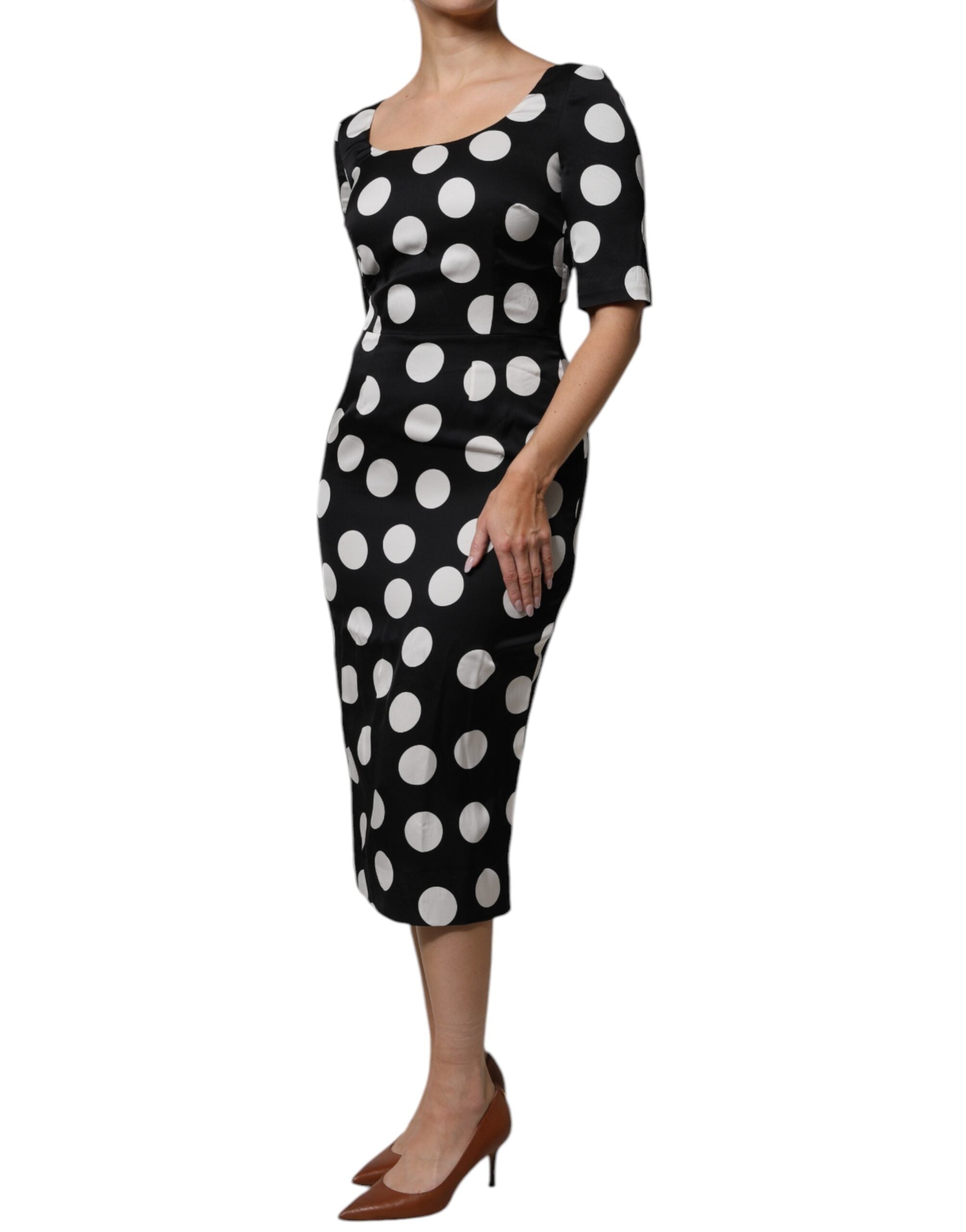Indulge in the exquisite Dolce & Gabbana Black White Silk Polka Dots Sheath Midi Dress, a timeless piece that embodies elegance and sophistication for any occasion.