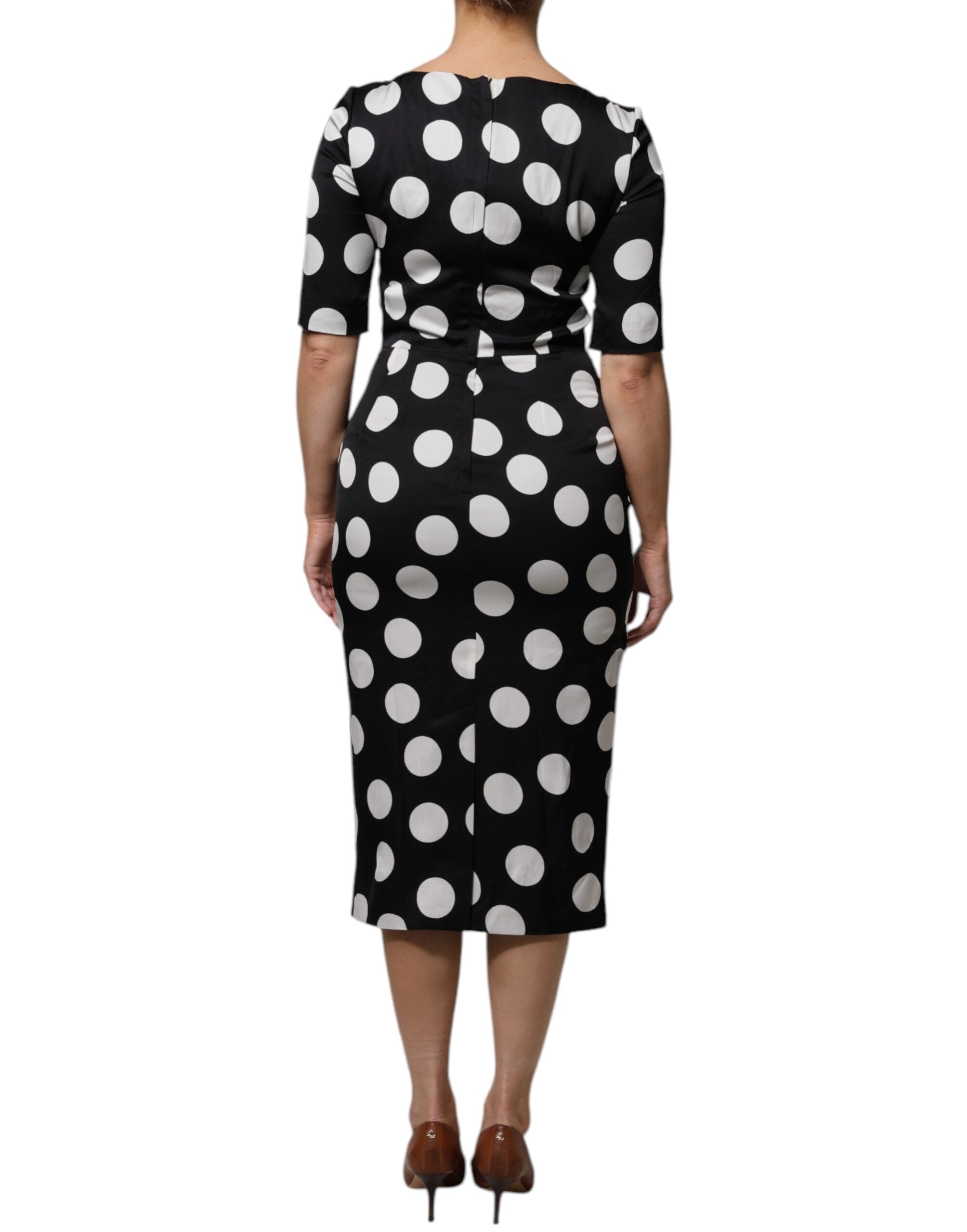 Experience the allure of the Dolce & Gabbana Black White Silk Polka Dots Sheath Midi Dress, a timeless masterpiece crafted from luxurious silk, perfect for any elegant occasion.