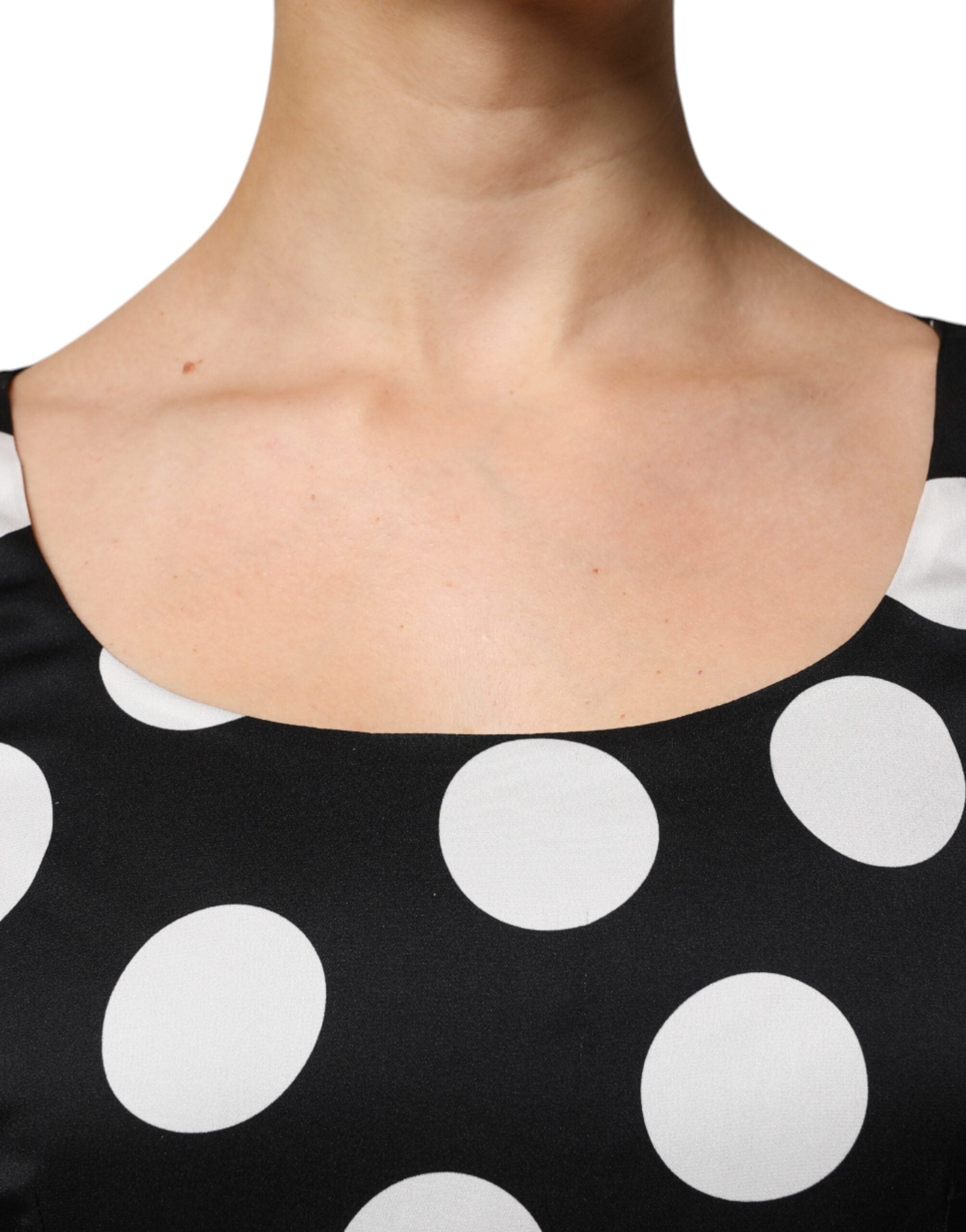 Indulge in the exquisite Dolce & Gabbana Black White Silk Polka Dots Sheath Midi Dress, a timeless masterpiece of Italian craftsmanship that elevates elegance and allure.