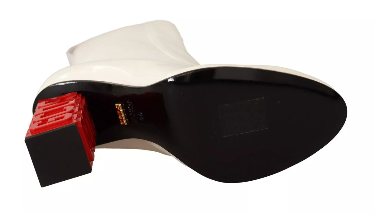 Step into the world of GCDS with these exquisite White Leather Fabric Red Logo Heel Ankle Boots, where luxurious craftsmanship meets bold design for a captivating presence.