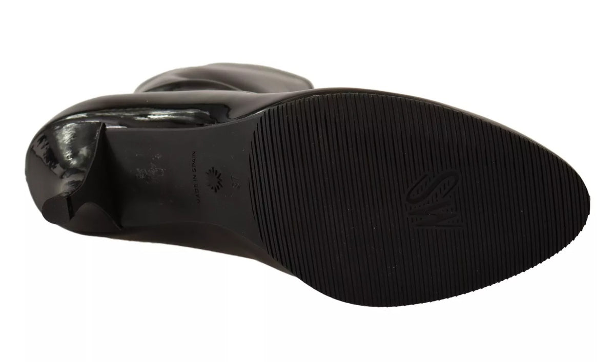 Step into sophistication with Stuart Weitzman's Black Patent Leather High Heels, where exquisite craftsmanship meets timeless elegance, perfect for the discerning individual.
