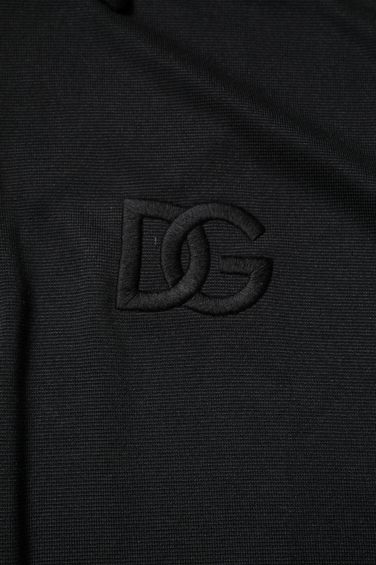 Indulge in the exquisite Dolce & Gabbana Black DG Logo Collared Polo T-shirt, a masterpiece of luxurious comfort and sophisticated design, perfect for the discerning individual.