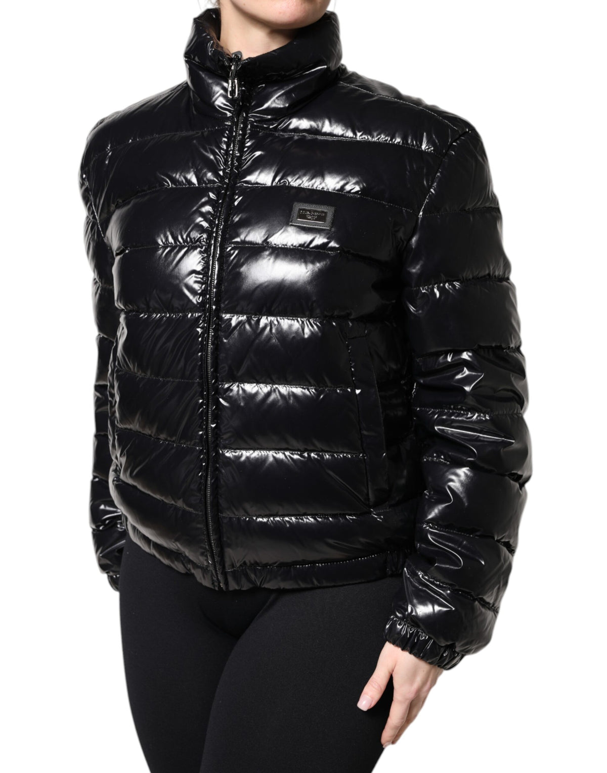 Discover the Dolce & Gabbana Black Logo Plaque Full Zip Puffer Jacket, a masterpiece of Italian craftsmanship, blending luxurious materials with timeless elegance for the discerning style connoisseur.