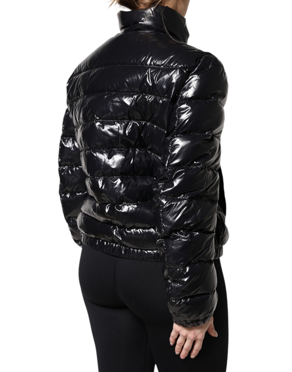 Indulge in the exquisite Dolce & Gabbana Black Logo Plaque Full Zip Puffer Jacket, a timeless blend of luxurious materials and impeccable Italian craftsmanship, perfect for the discerning connoisseur.