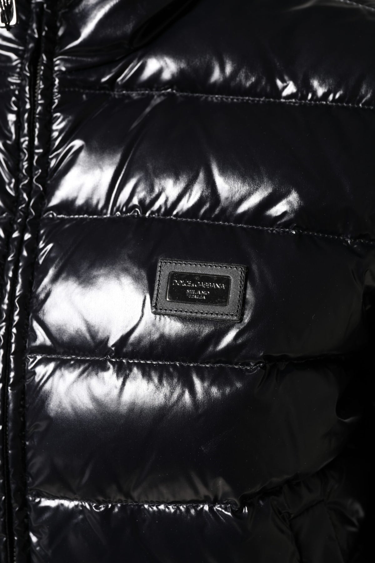 Indulge in the exquisite Dolce & Gabbana Black Logo Plaque Full Zip Puffer Jacket, where luxurious materials and Italian craftsmanship elevate your style to new heights.