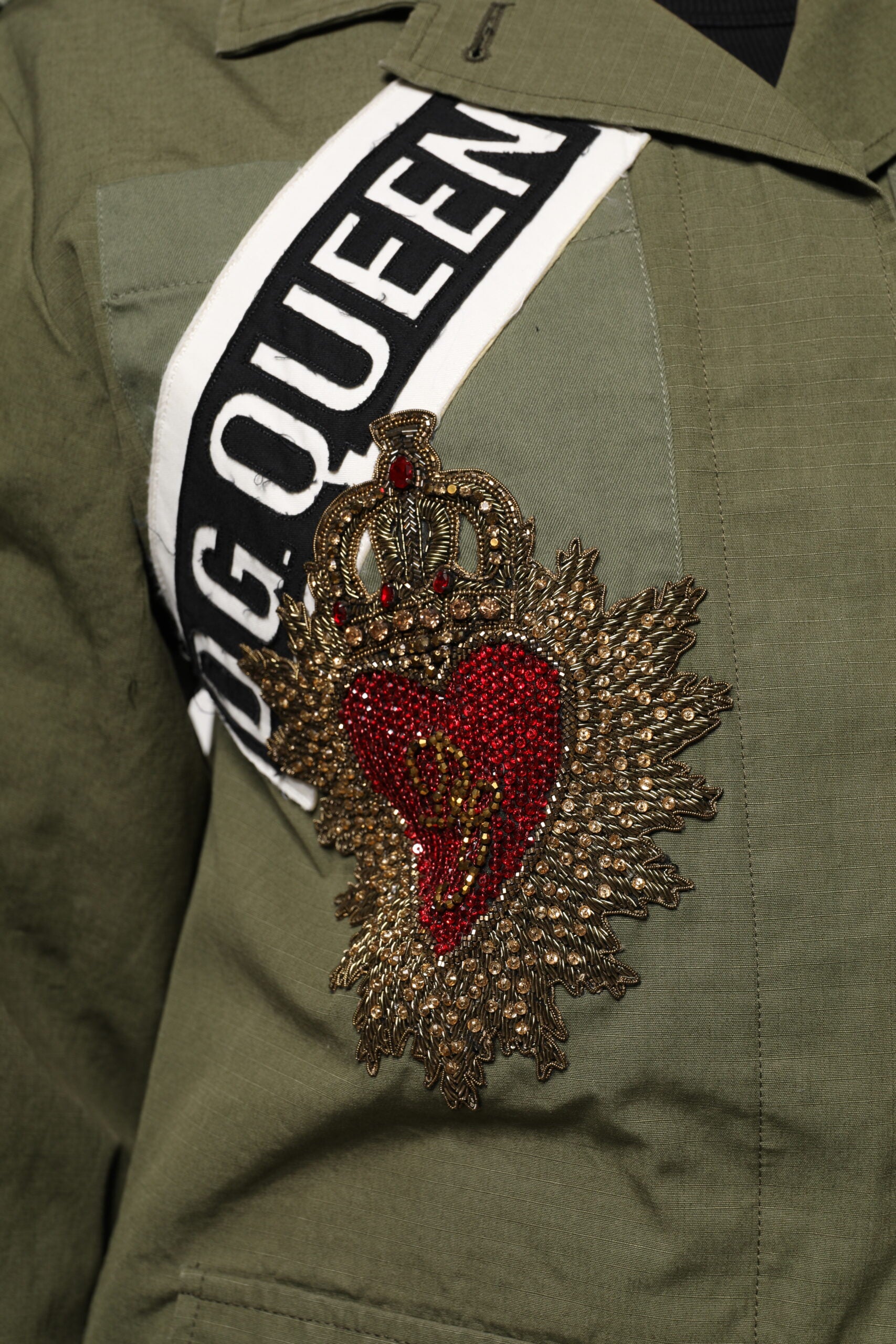 Elevate your style with the Dolce & Gabbana Military Green Queen Embellished Coat Jacket, a masterpiece of Italian craftsmanship that embodies luxury and refined femininity.
