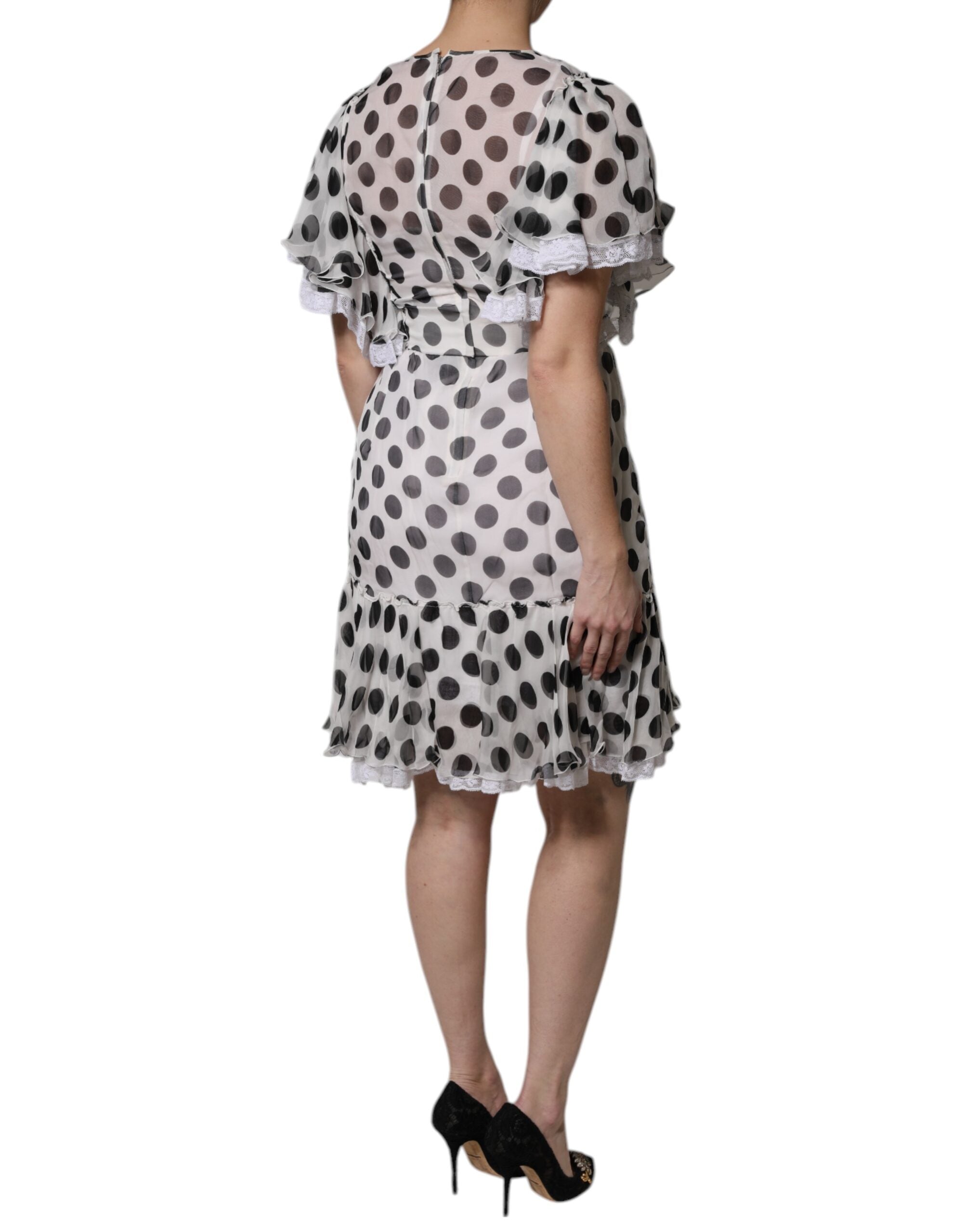 Indulge in the exquisite Dolce & Gabbana White Polka Dotted Silk Blend A-line Dress, a masterpiece of couture elegance that embodies timeless sophistication and playful charm.