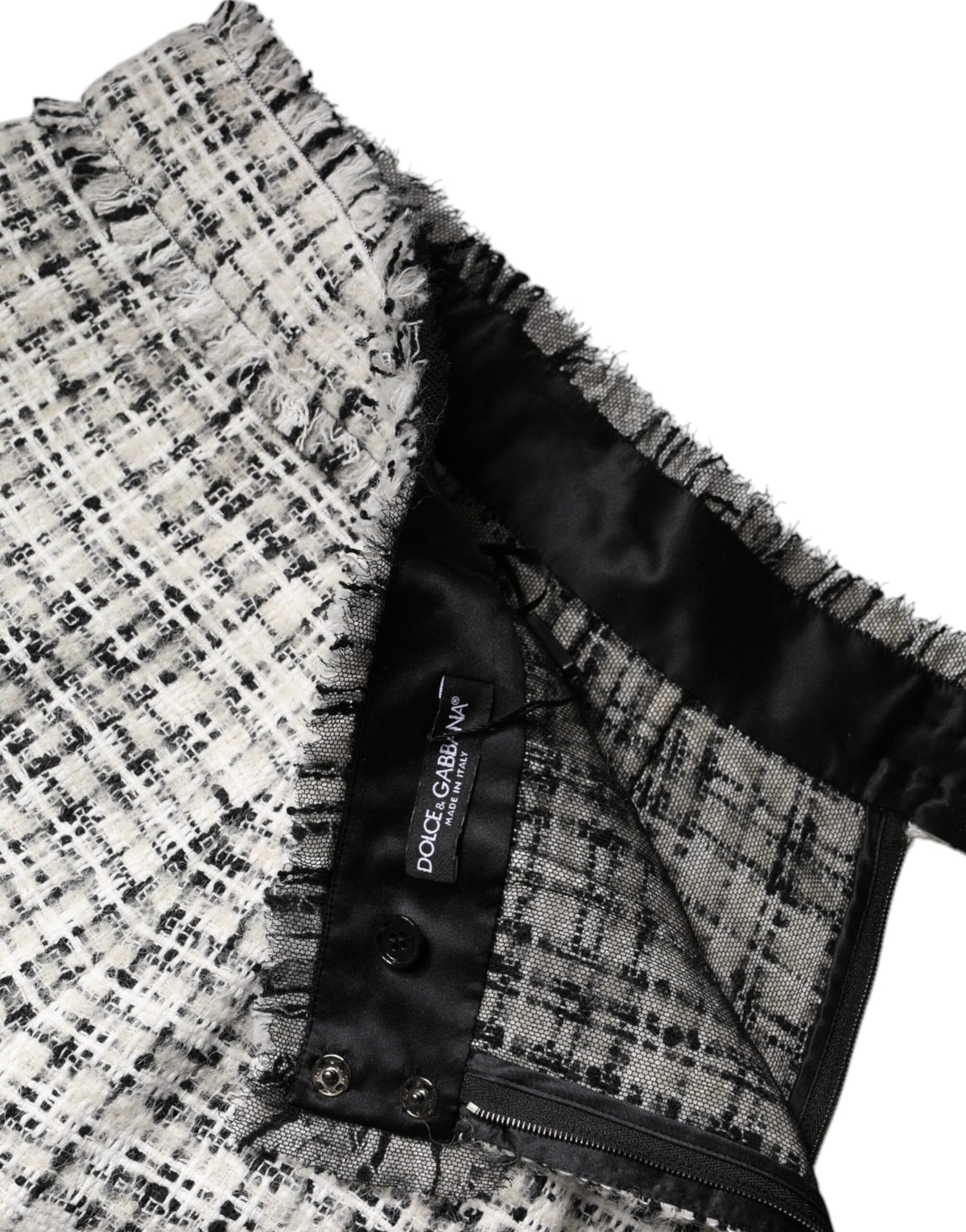 Discover the Dolce & Gabbana White Black High Waist Tartan Tweed Mini Skirt, a luxurious blend of exquisite fibers, embodying timeless elegance and Italian craftsmanship.