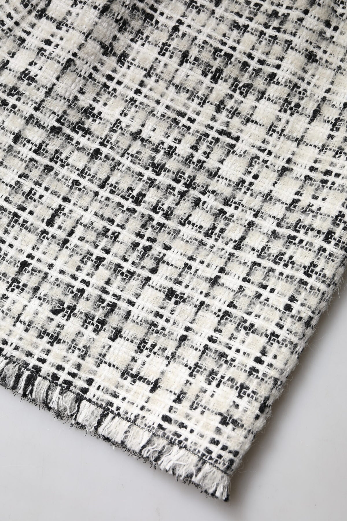 Discover the Dolce & Gabbana White Black High Waist Tartan Tweed Mini Skirt, a luxurious blend of exquisite fibers and timeless design that elevates your wardrobe with Italian craftsmanship.