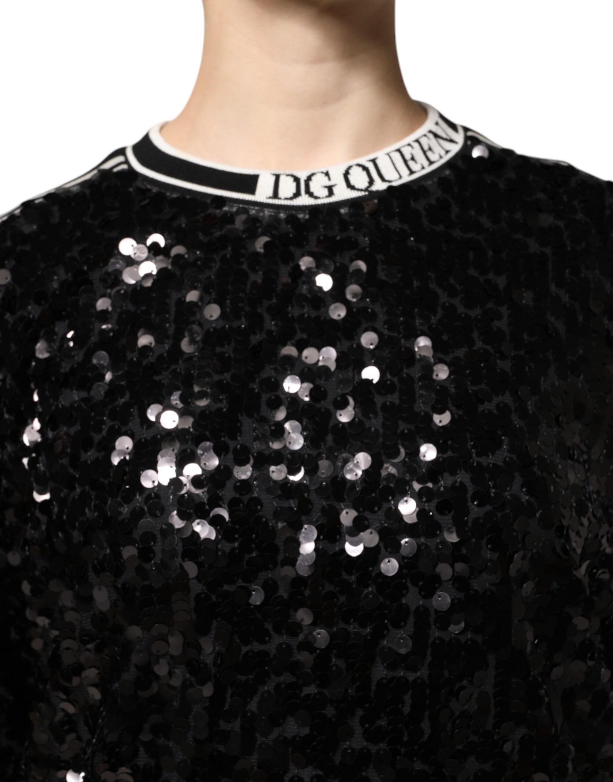 Elevate your wardrobe with the Dolce & Gabbana Black DG Queen Sequin Pullover Sweater, a masterpiece of silk and polyester that embodies luxurious craftsmanship and timeless elegance.