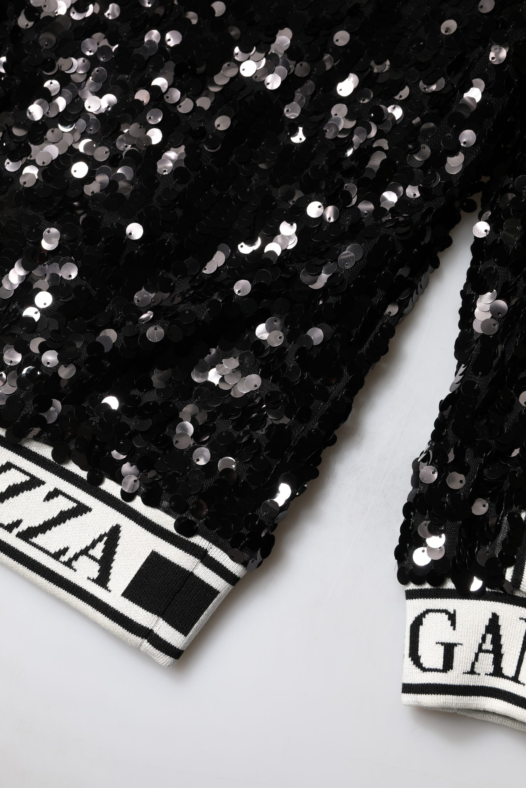 Elevate your wardrobe with the Dolce & Gabbana Black DG Queen Sequin Pullover Sweater, a luxurious blend of silk and polyester that embodies haute couture elegance.