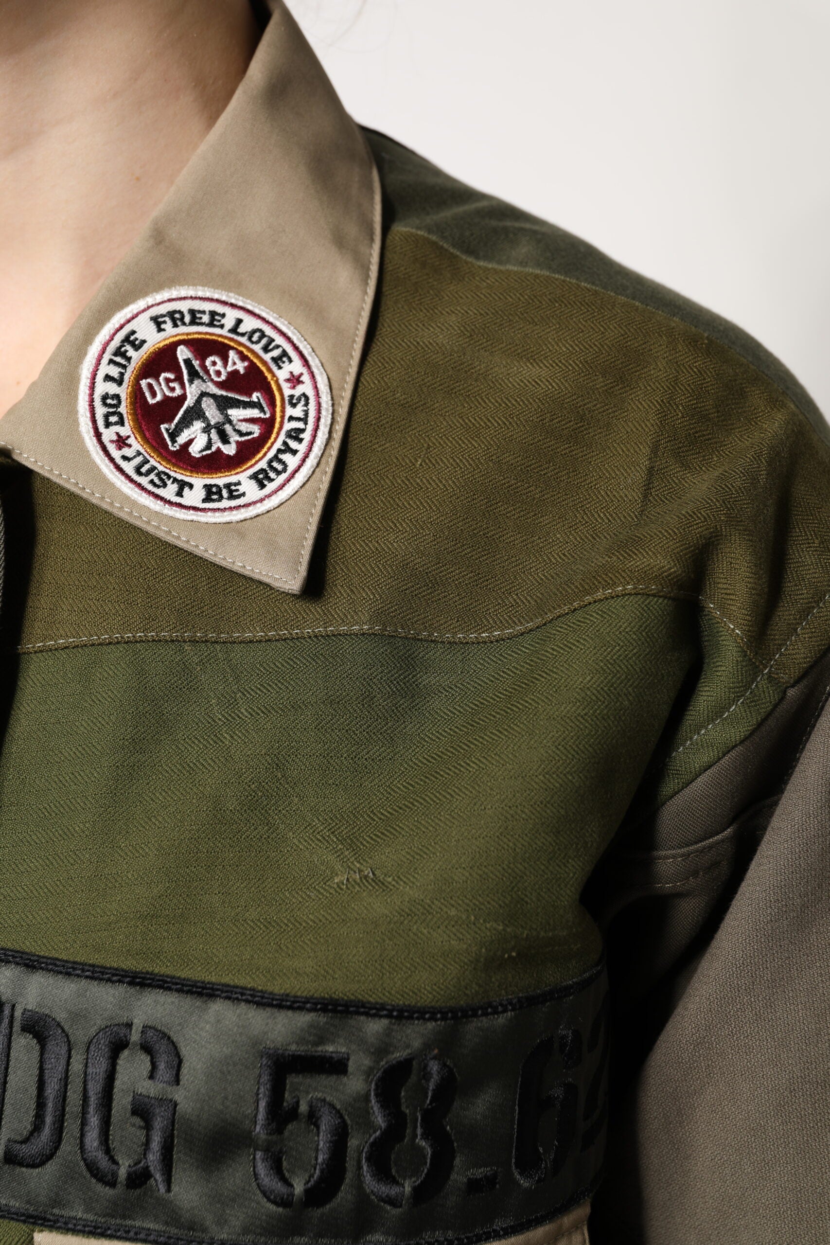 Elevate your wardrobe with the Dolce & Gabbana Military Green Cotton Button Down Jacket, a masterpiece of Italian craftsmanship that embodies timeless luxury and sophisticated style.