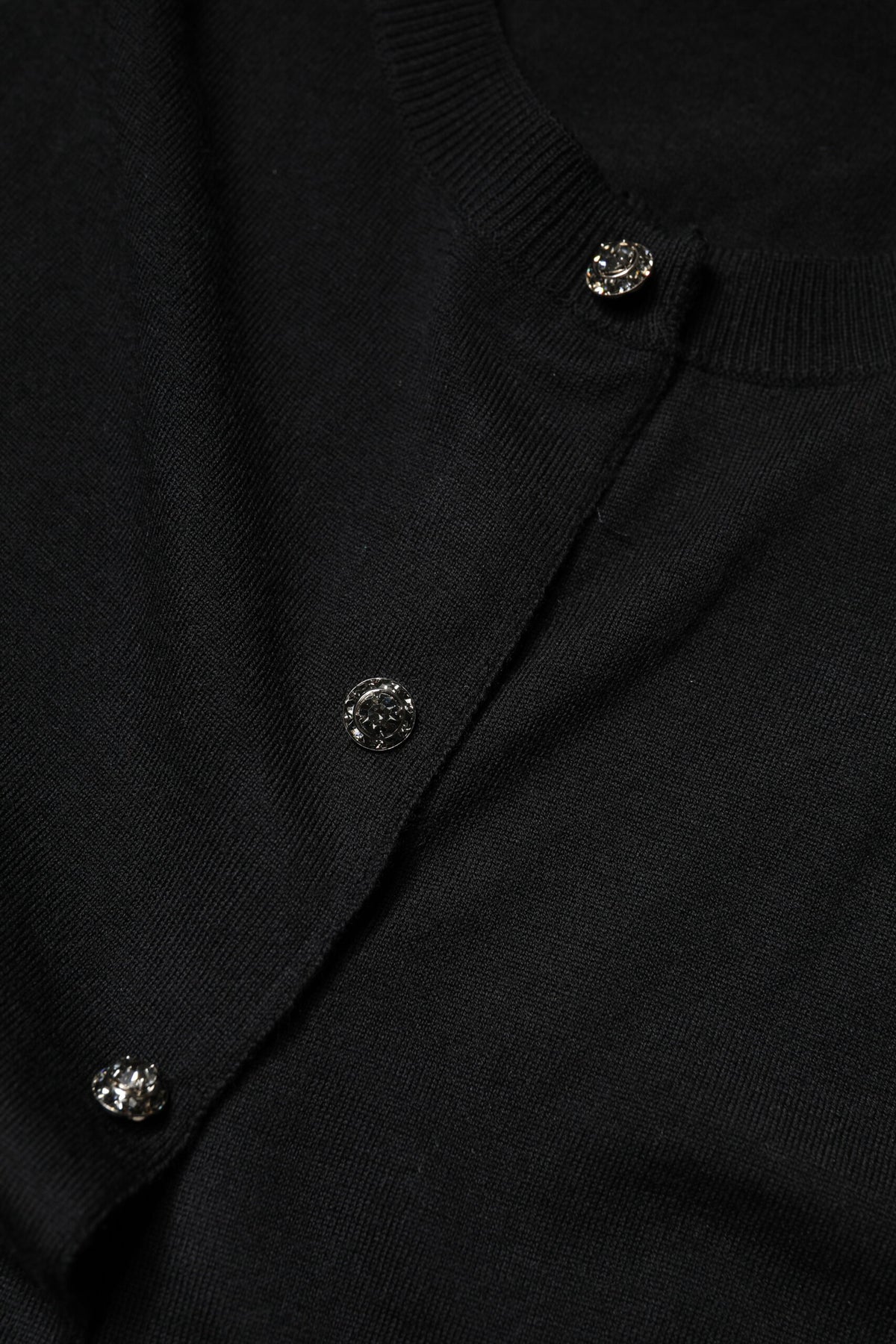 Discover the Dolce & Gabbana Black Button Down Short Sleeve Blouse, crafted from luxurious virgin wool, embodying sophistication and timeless elegance for the discerning individual.