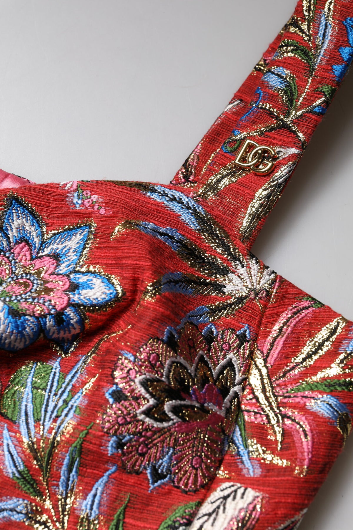 Experience the exquisite allure of Dolce & Gabbana's Red Floral Brocade Cropped Bustier Corset Top, a masterpiece of Italian craftsmanship that redefines luxury and sophistication.