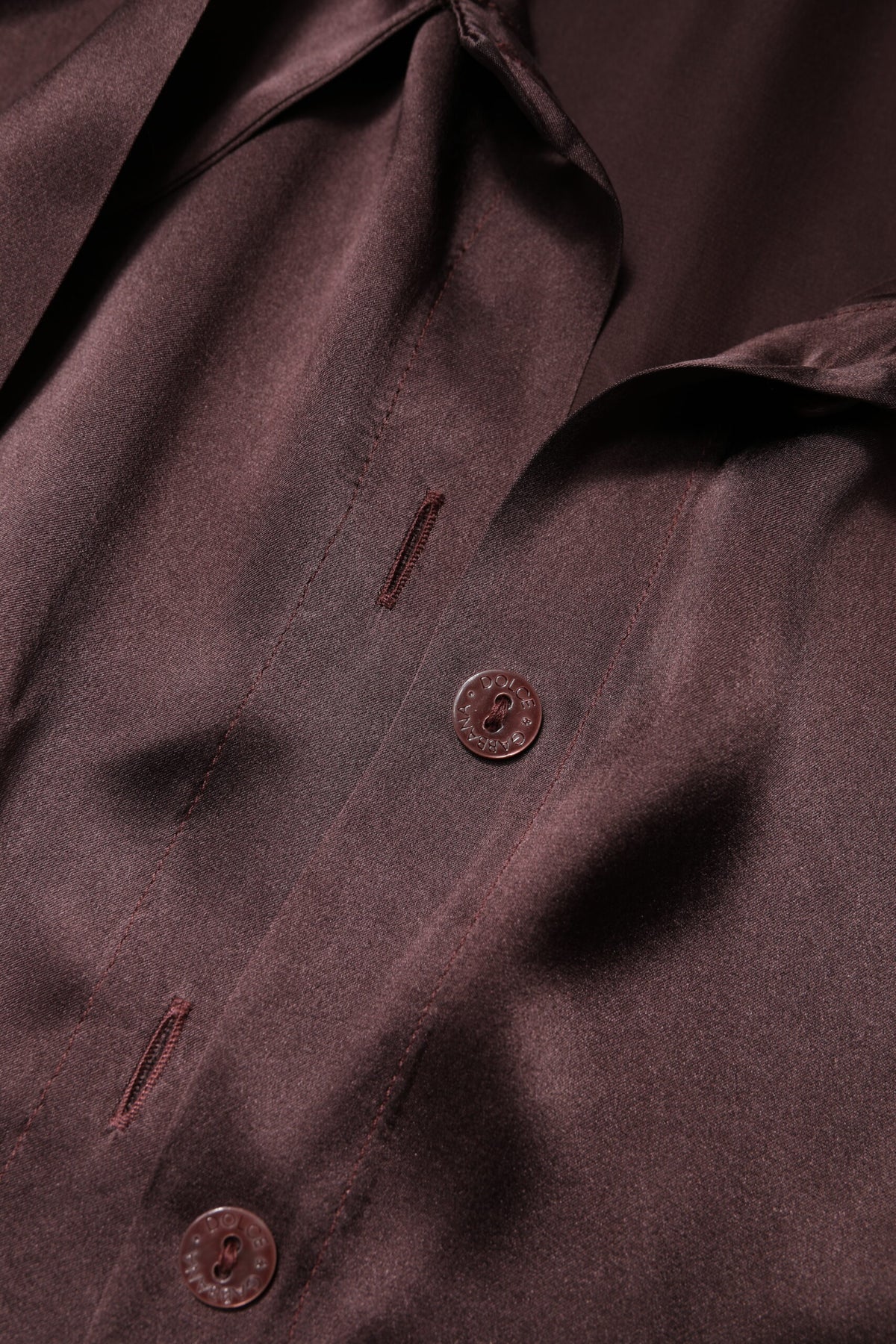 Discover the Dolce & Gabbana Brown Ascot Collar Long Sleeve Blouse, a silk masterpiece that embodies Italian craftsmanship and timeless elegance for the discerning individual.