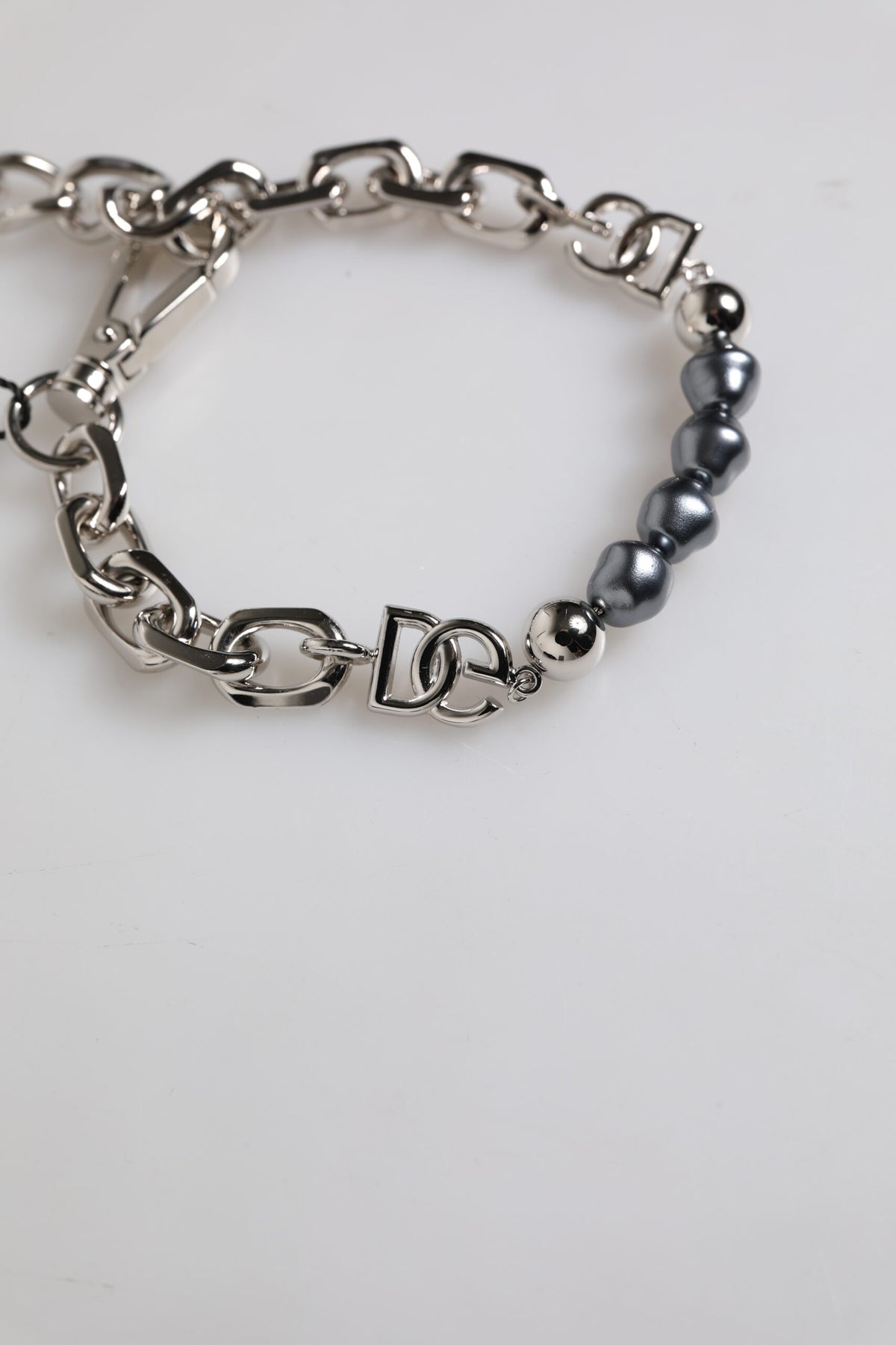 Elevate your elegance with the Dolce & Gabbana Silver Tone Chain Lobster Clasp Logo Gray Pearls Bracelet, a masterpiece of Italian craftsmanship that embodies luxury and sophistication.