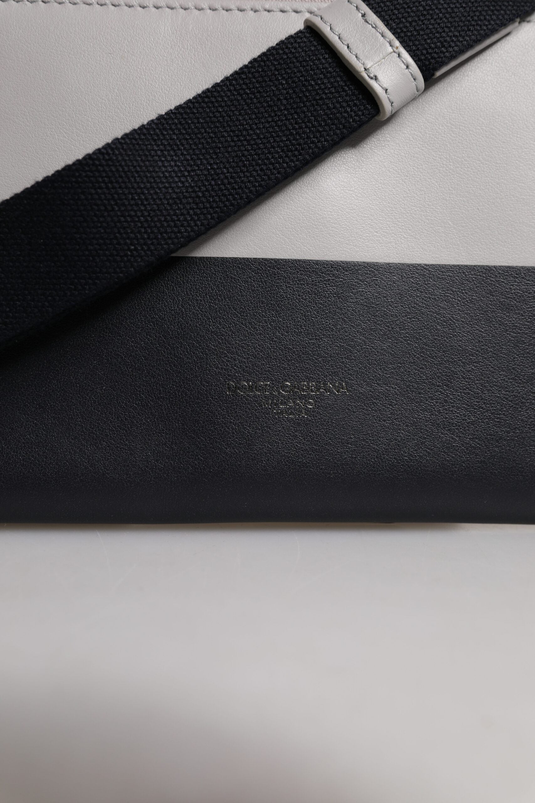 Discover the Dolce & Gabbana Black White Leather Logo Embossed Crossbody Bag, a masterpiece of Italian craftsmanship that embodies luxury and sophistication for the discerning individual.