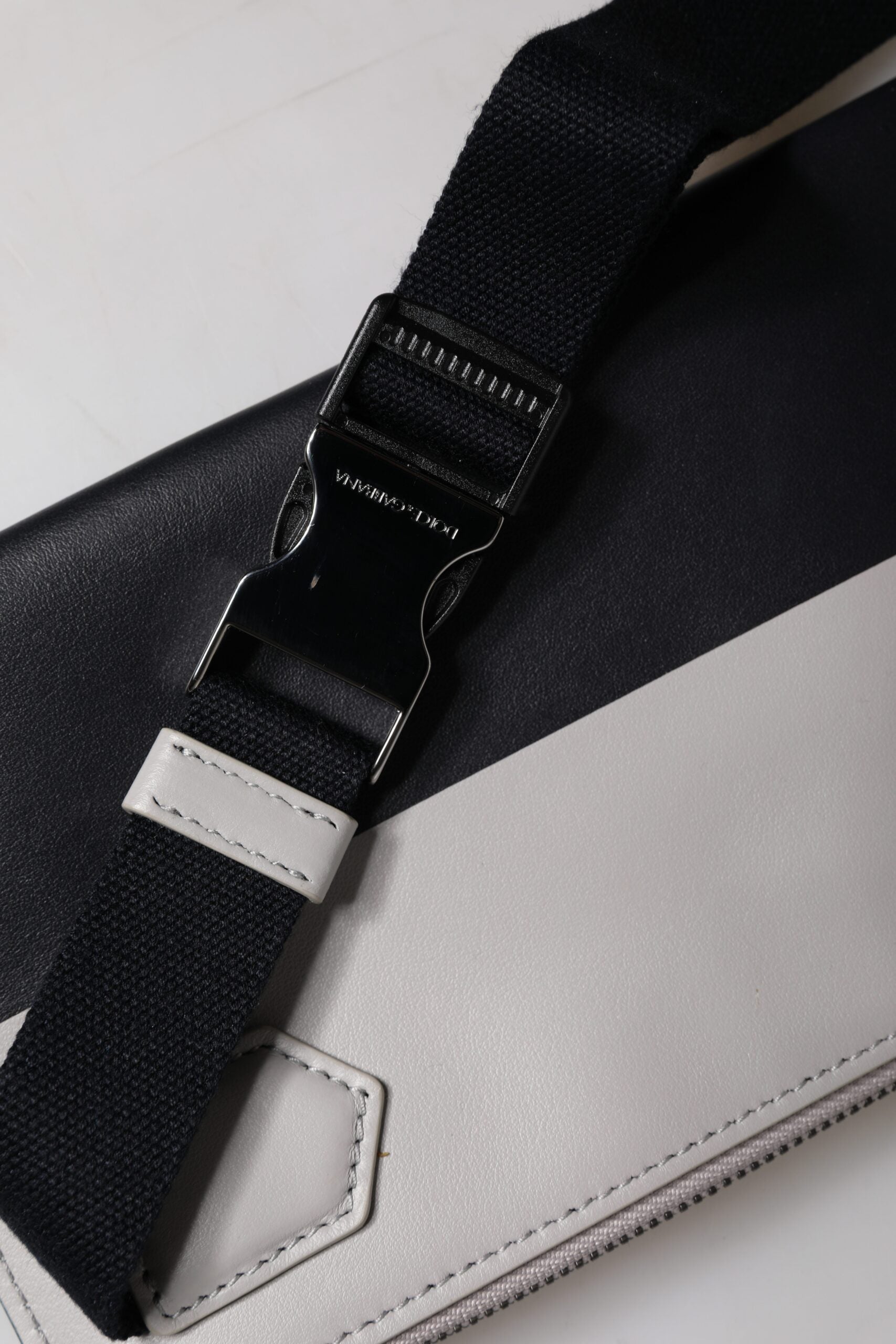 Discover the exquisite Dolce & Gabbana Black White Leather Logo Embossed Crossbody Bag, a masterpiece of Italian craftsmanship that elevates your style with timeless luxury.