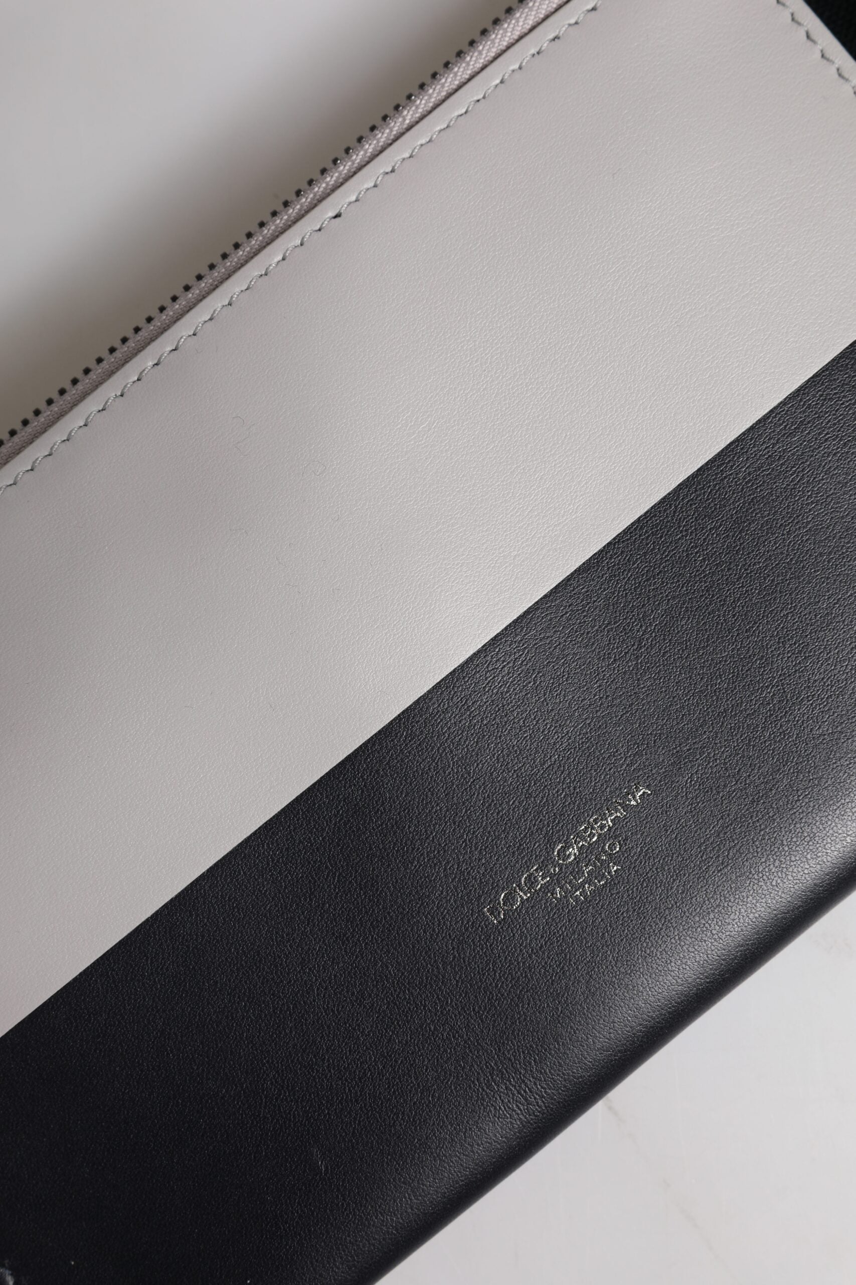 Discover the Dolce & Gabbana Black White Leather Logo Embossed Crossbody Bag, a masterpiece of Italian craftsmanship that elevates your style with luxurious elegance.