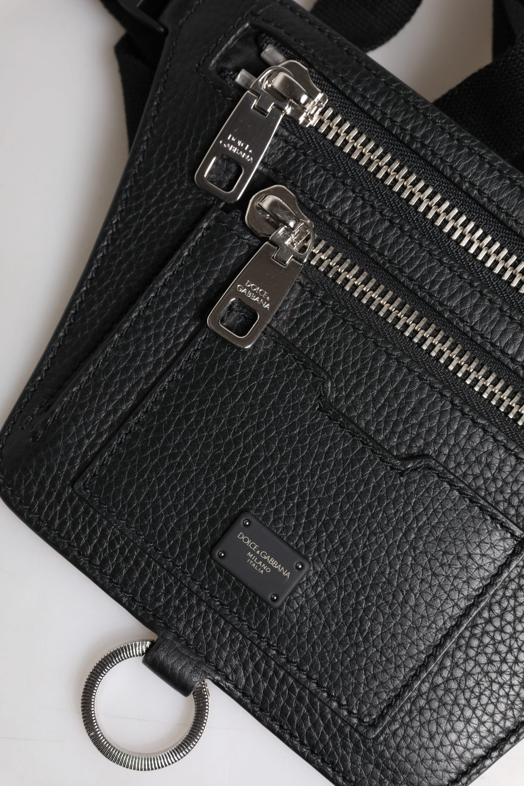 Discover the Dolce & Gabbana Black Calfskin Logo Plaque Fanny Pack, an embodiment of luxury craftsmanship and versatile elegance for the discerning individual.