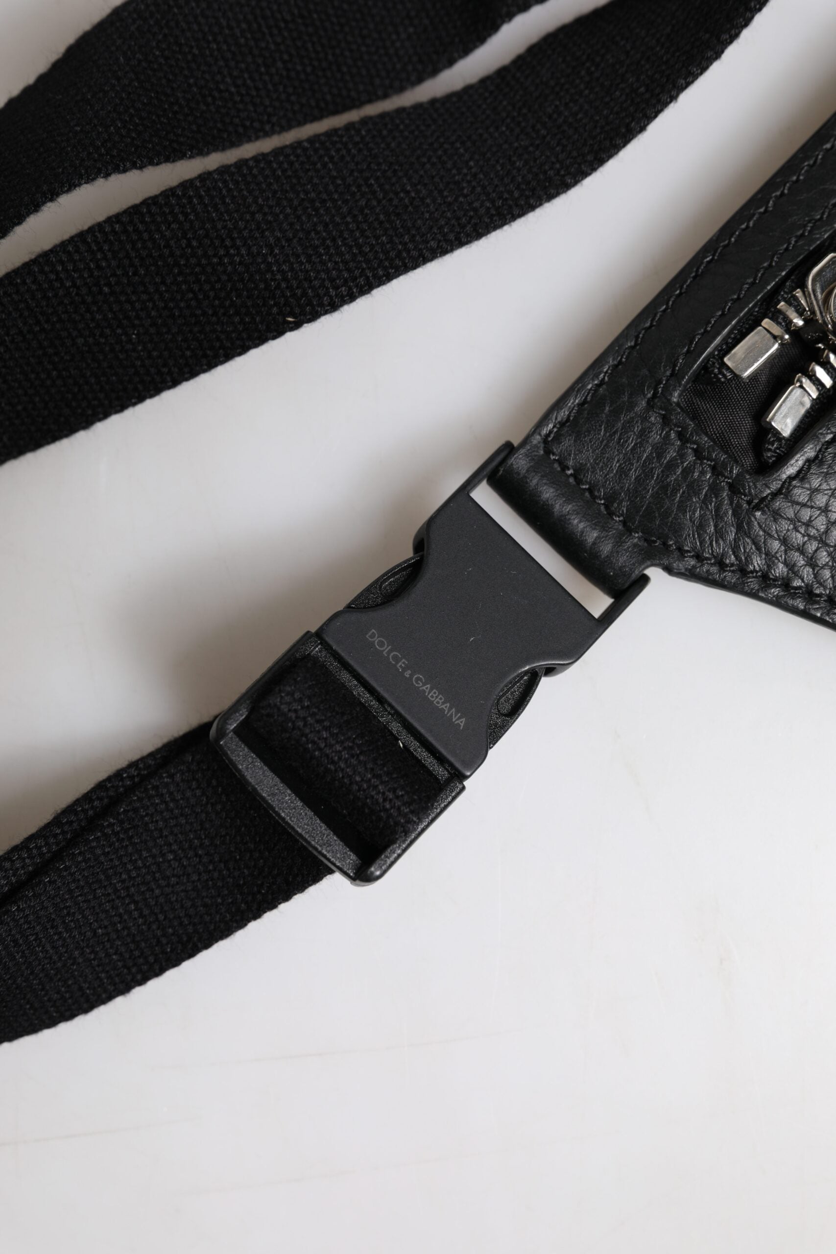 Elevate your style with the Dolce & Gabbana Black Calfskin Logo Plaque Fanny Pack, a blend of exquisite craftsmanship and versatile luxury for the discerning individual.