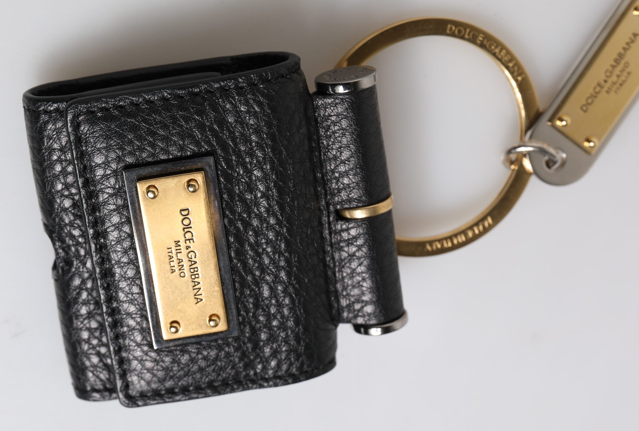 Discover the exquisite Dolce & Gabbana Black Leather Strap Airpods Case, a luxurious blend of Italian craftsmanship and opulent design, perfect for the discerning individual.