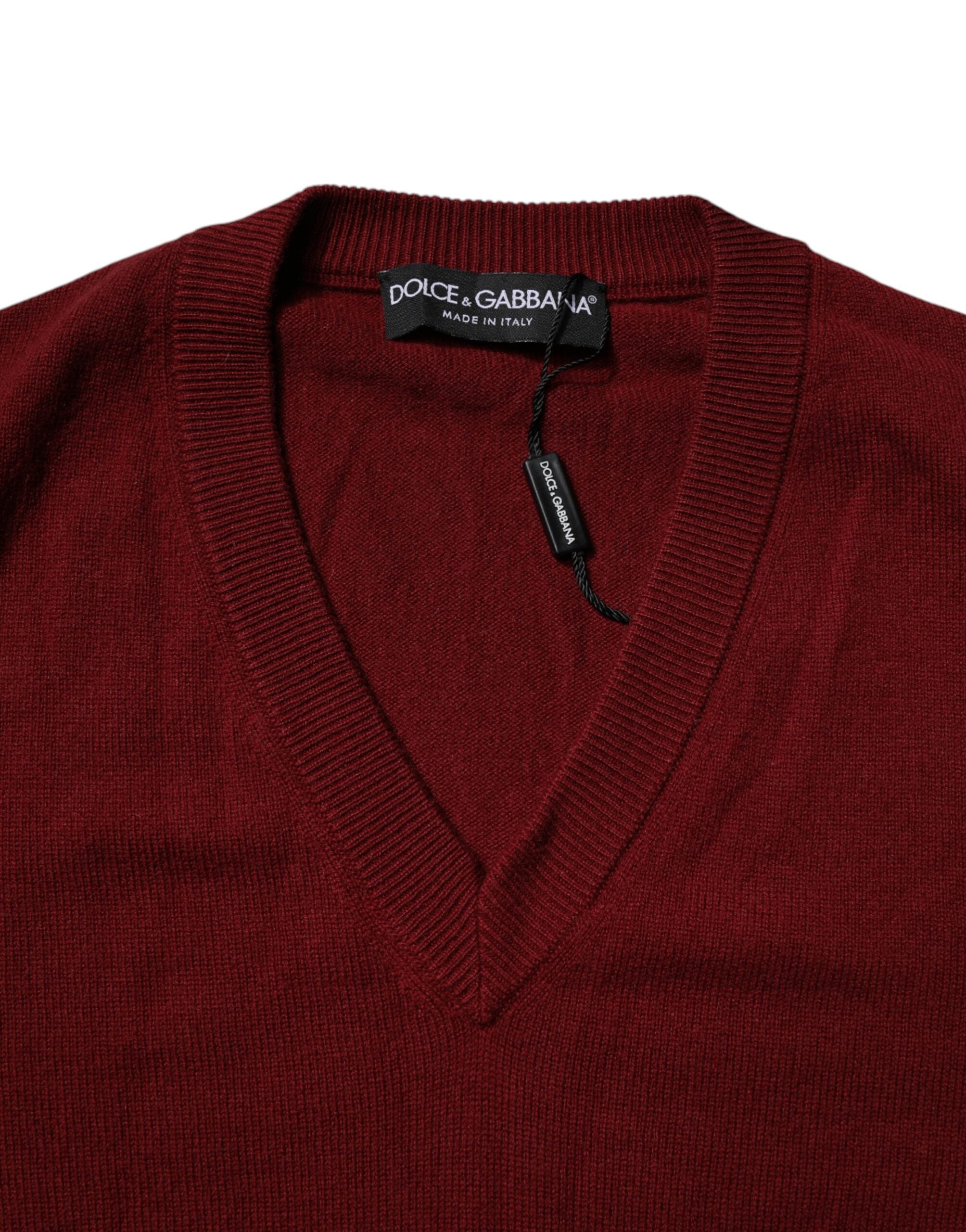 Elevate your wardrobe with the Dolce & Gabbana Maroon Cashmere V-neck Pullover Sweater, a masterpiece of Italian craftsmanship that embodies timeless luxury and sophistication.