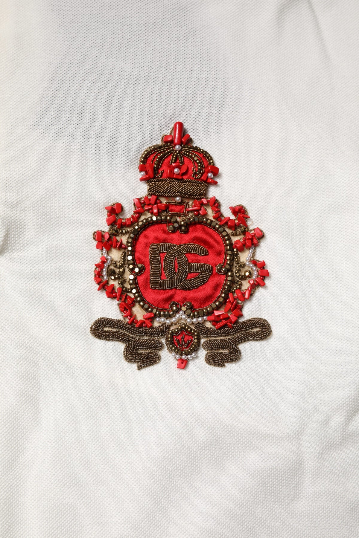 Indulge in the exquisite allure of Dolce & Gabbana's White Cotton Logo Collared Polo, a timeless masterpiece that embodies luxury and sophistication for the discerning individual.