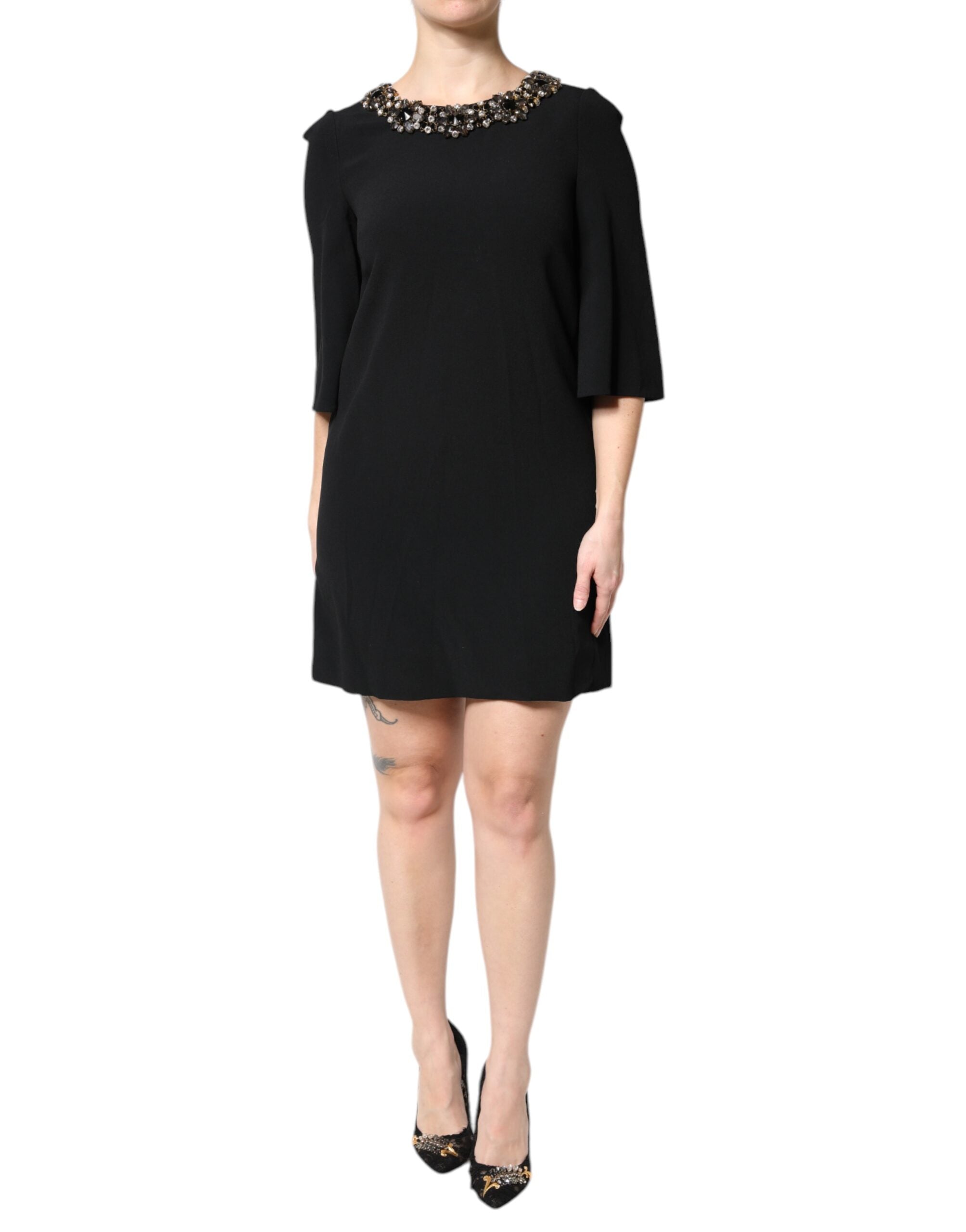 Indulge in the exquisite allure of the Dolce & Gabbana Black Crystal Embellished Round Neck Mini Dress, a masterpiece of Italian craftsmanship that elevates your elegance for any occasion.
