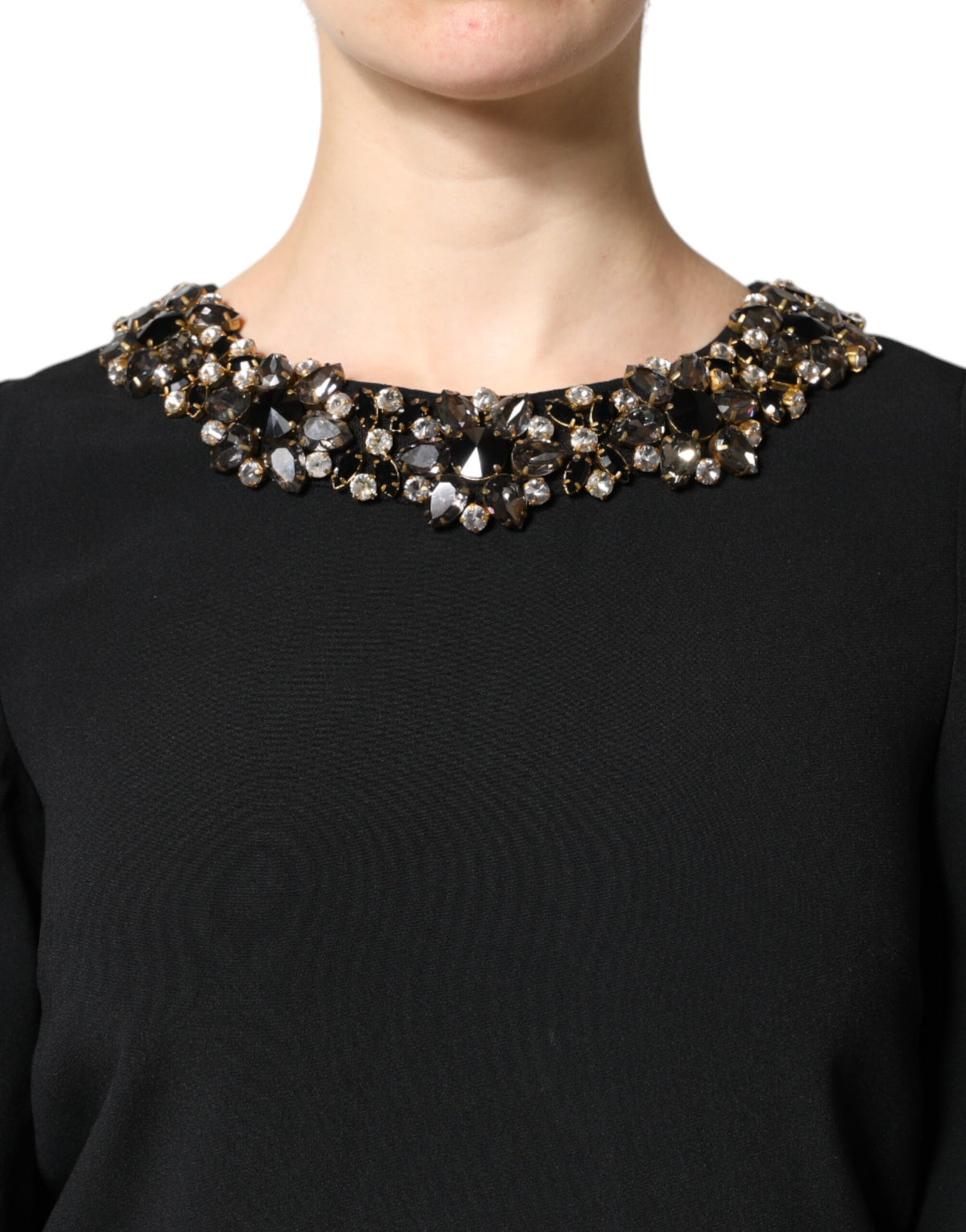 Elevate your elegance with the Dolce & Gabbana Black Crystal Embellished Round Neck Mini Dress, a masterpiece of Italian craftsmanship adorned with exquisite crystals, perfect for unforgettable soirées.
