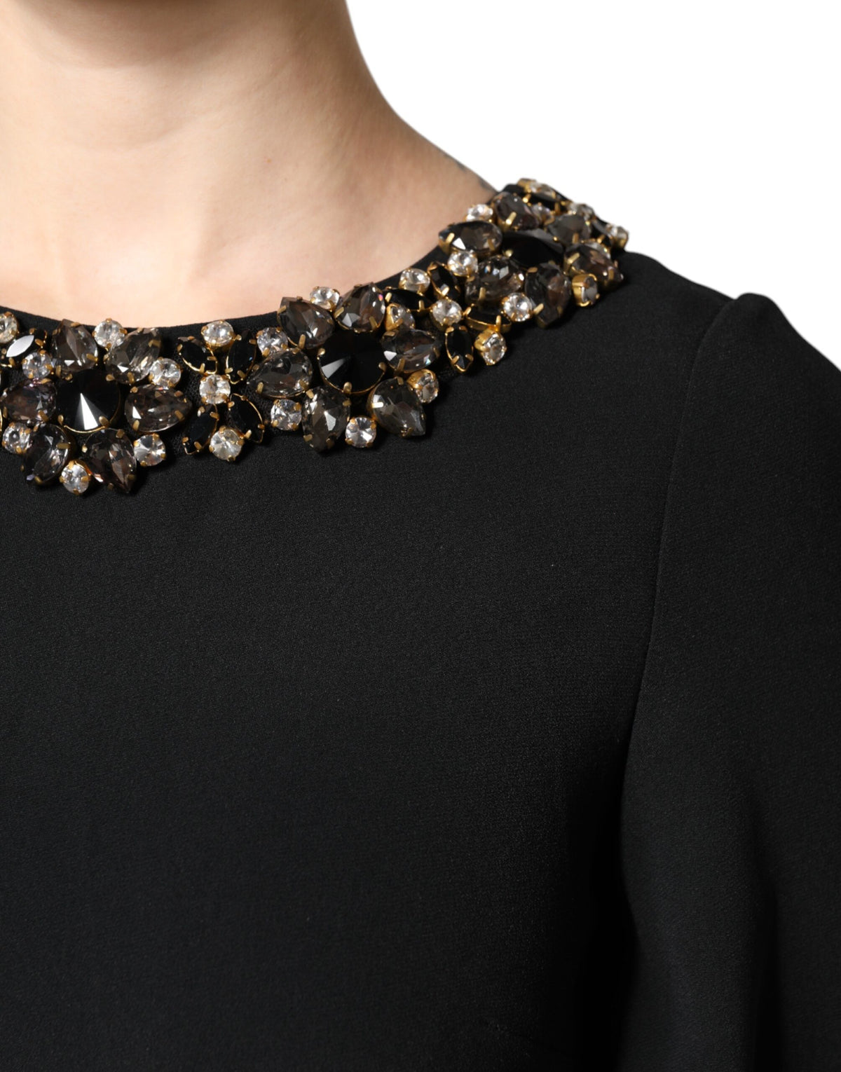 Indulge in the exquisite allure of the Dolce & Gabbana Black Crystal Embellished Round Neck Mini Dress, where luxurious craftsmanship meets timeless elegance for unforgettable moments.