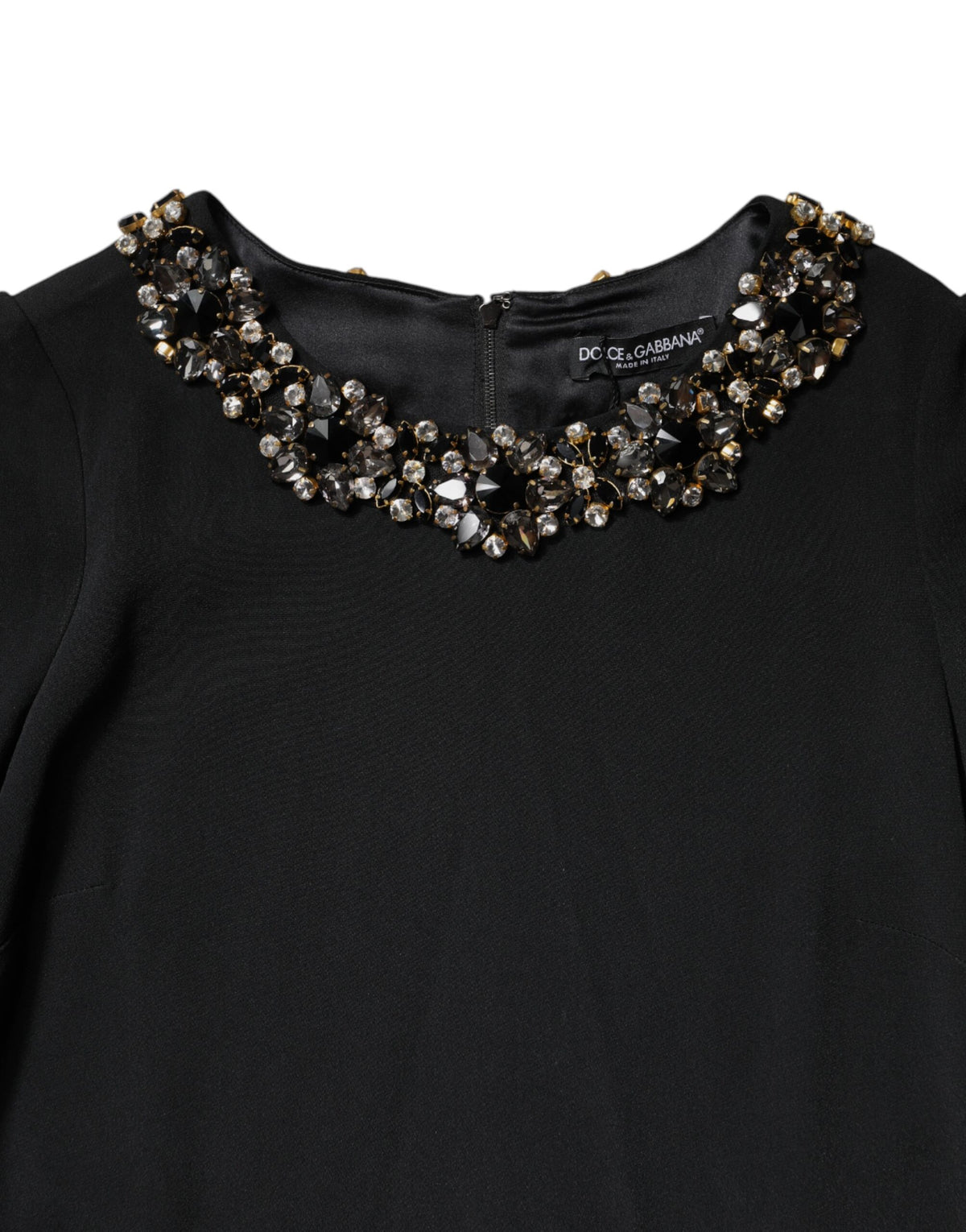 Indulge in the exquisite allure of the Dolce & Gabbana Black Crystal Embellished Round Neck Mini Dress, a masterpiece of Italian craftsmanship that elevates your elegance for any occasion.