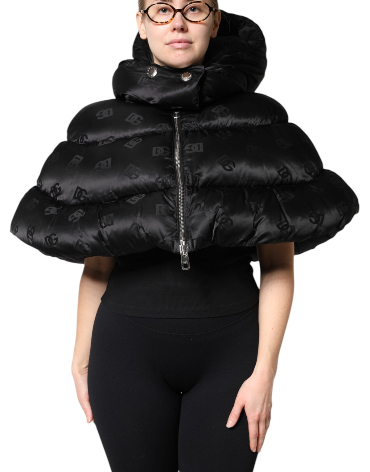 Indulge in the exquisite Dolce & Gabbana Black Padded Puffer Hooded Jacket, a luxurious blend of high-quality nylon and Italian craftsmanship, perfect for elevating your style.
