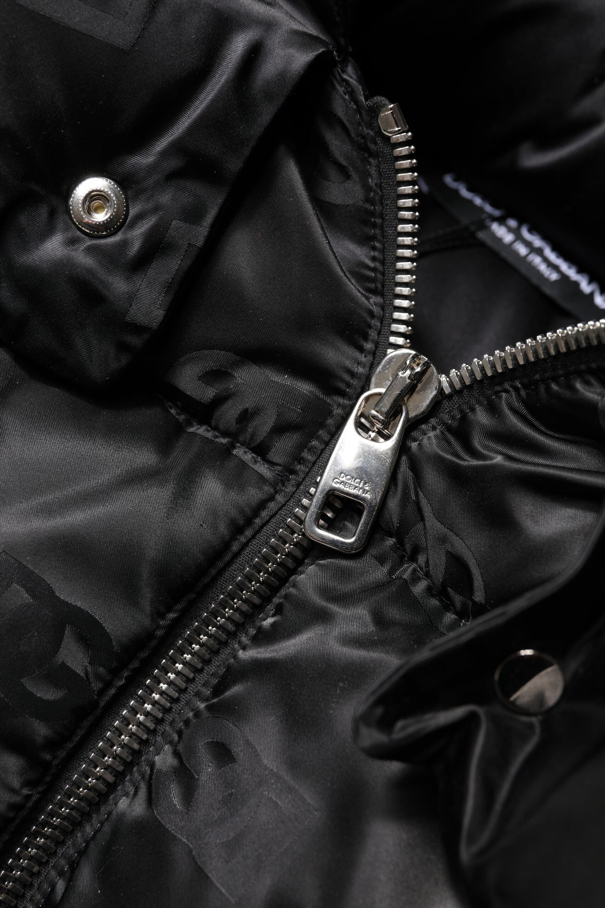 Indulge in the exquisite Dolce & Gabbana Black Padded Puffer Hooded Jacket, crafted from premium nylon for a chic silhouette that embodies luxury and sophistication.