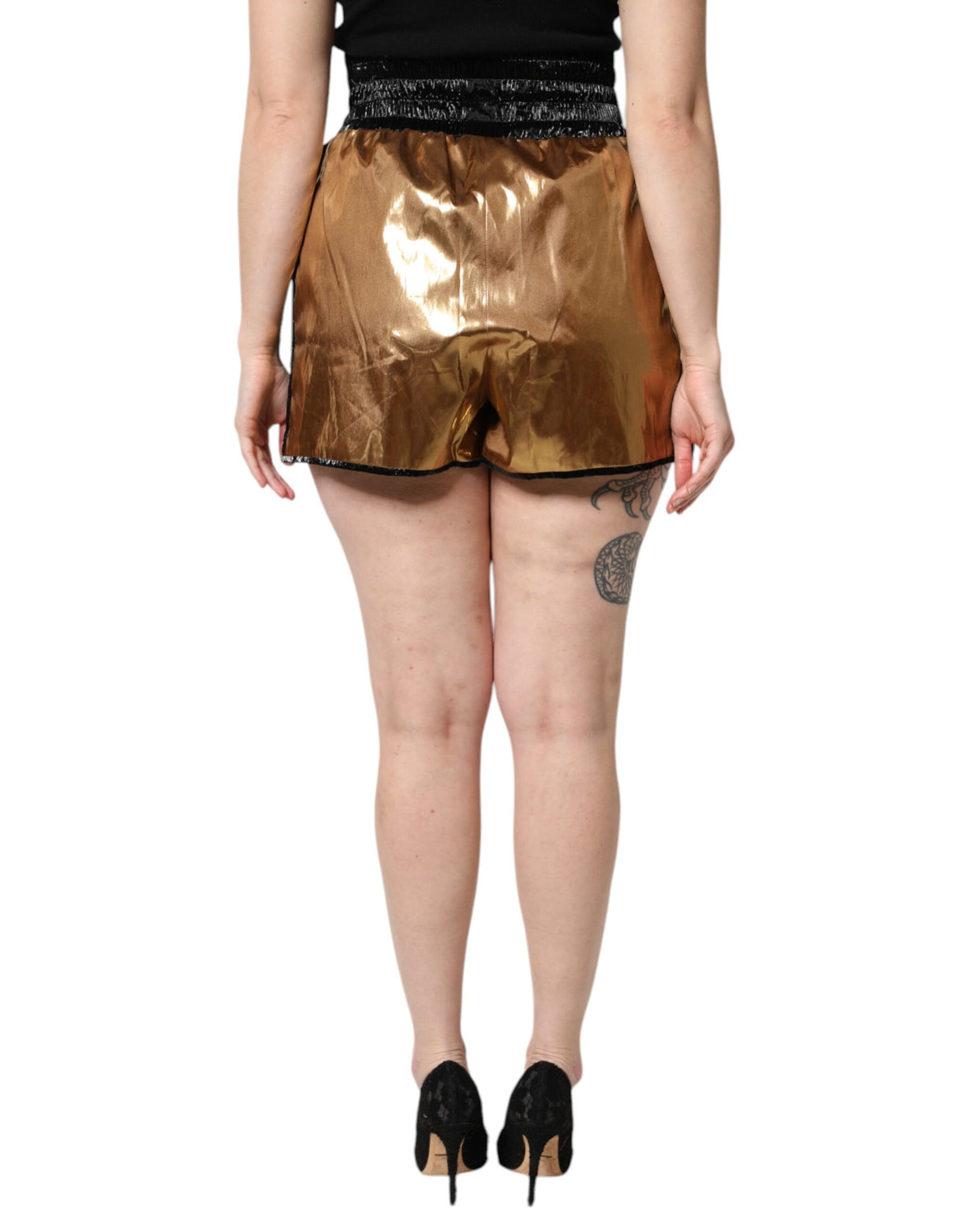 Experience the allure of Dolce & Gabbana's Metallic Gold High Waist Hotpants, crafted from premium materials to embody refined elegance and timeless luxury.
