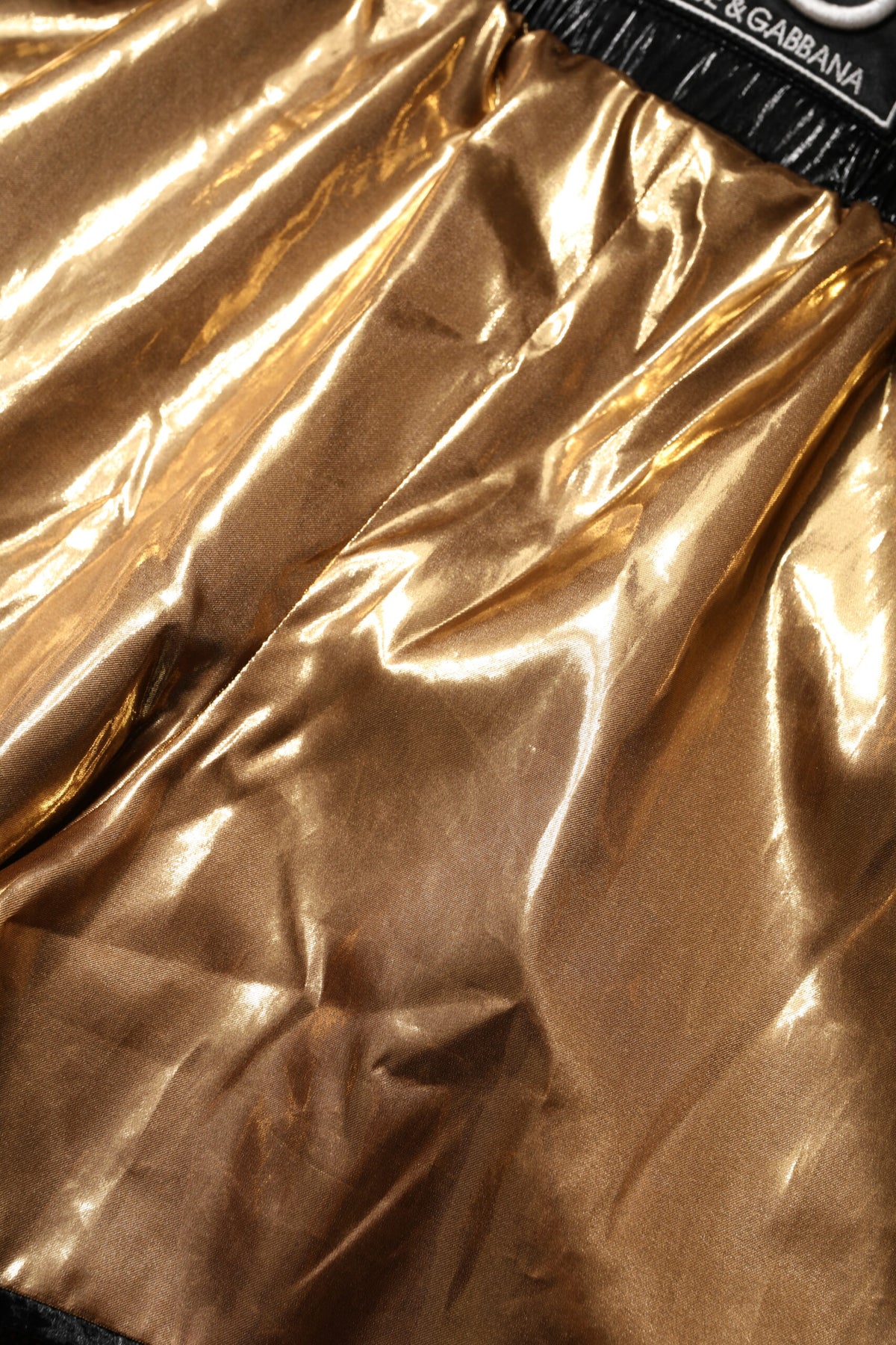 Indulge in the allure of Dolce & Gabbana's Metallic Gold High Waist Hotpants, a masterpiece of refined Italian craftsmanship that elevates your style with unparalleled elegance.