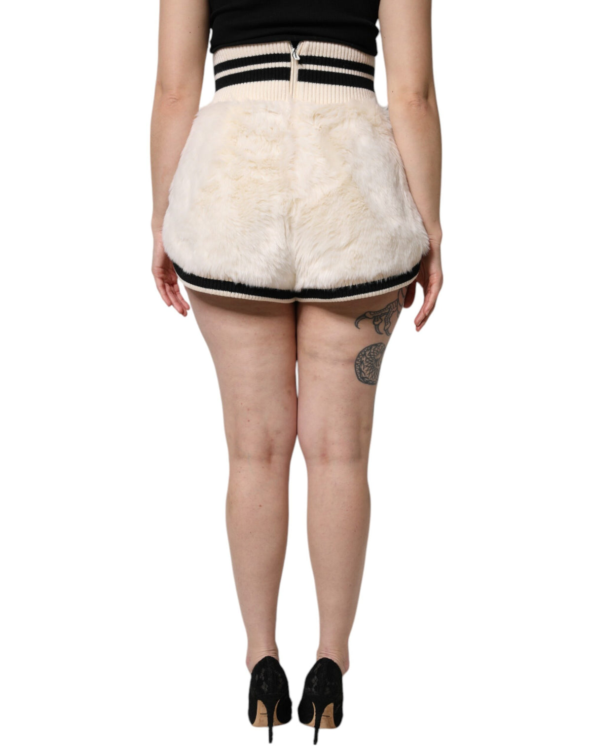 Indulge in the exquisite Dolce & Gabbana White Faux Fur High Waisted Hot Pants, where luxurious materials and Italian craftsmanship redefine sophistication for the discerning individual.