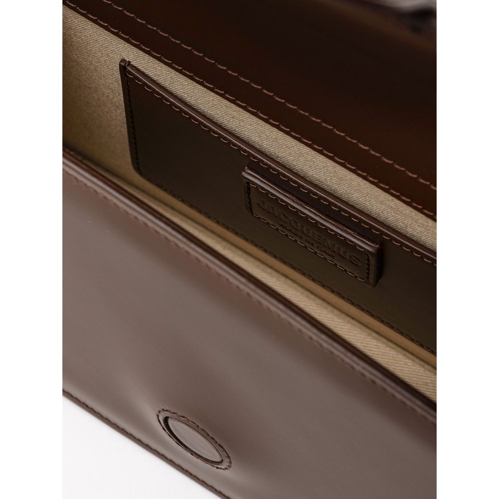 Indulge in the exquisite Jacquemus Brown Leather Handbag, a masterpiece of 100% leather craftsmanship that elevates your style with timeless elegance and versatility.