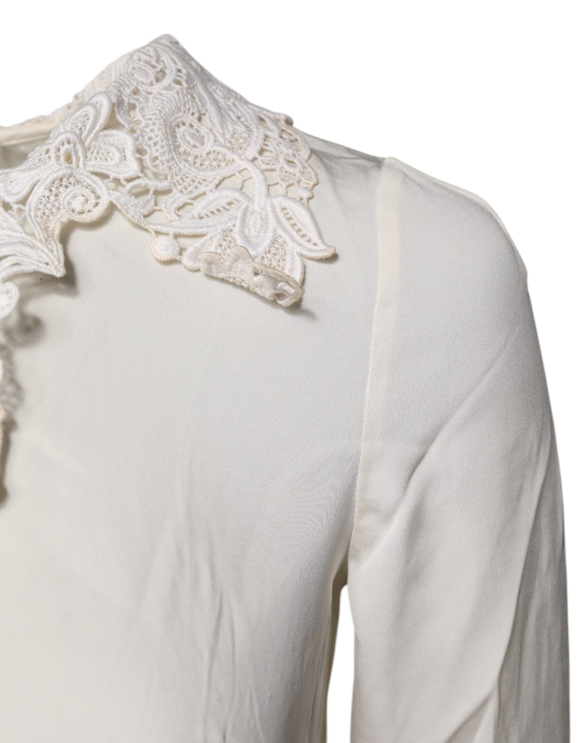 Indulge in the exquisite allure of Dolce & Gabbana's Cream Floral Lace Blouse, a masterpiece of silk and cotton that embodies timeless elegance and Italian craftsmanship.