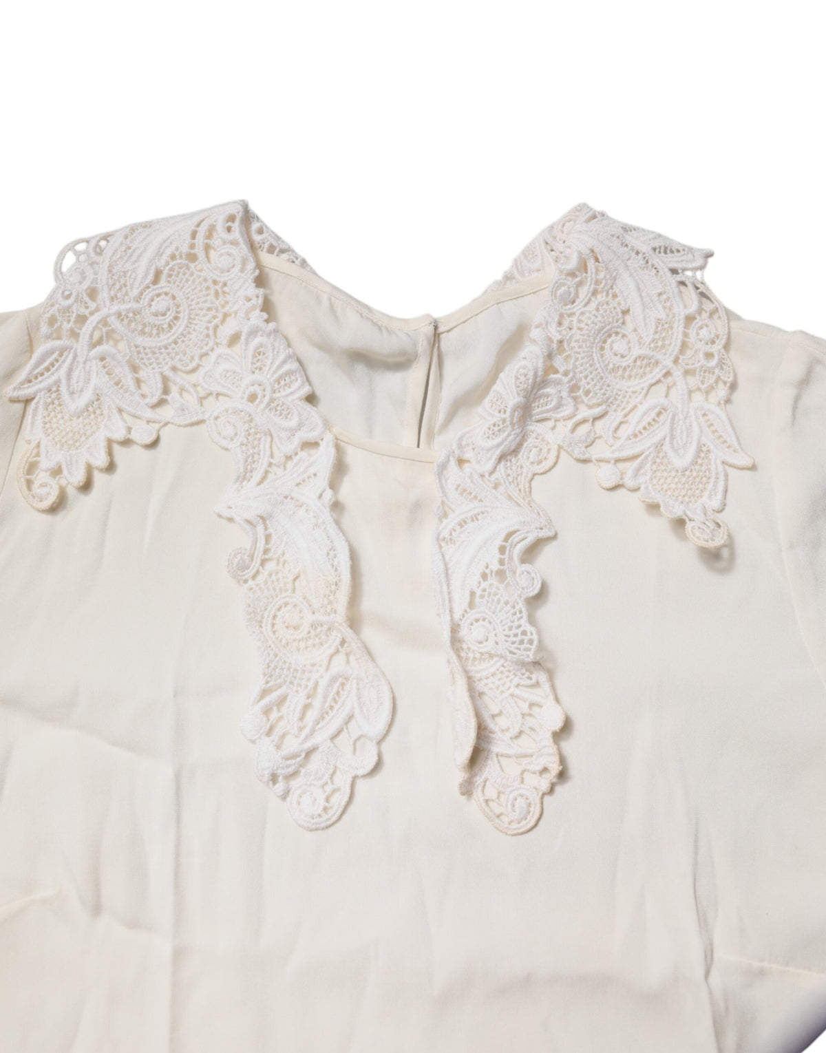 Indulge in the exquisite allure of Dolce & Gabbana's Cream Floral Lace Blouse, crafted from luxurious silk and cotton, embodying timeless elegance and sophistication.