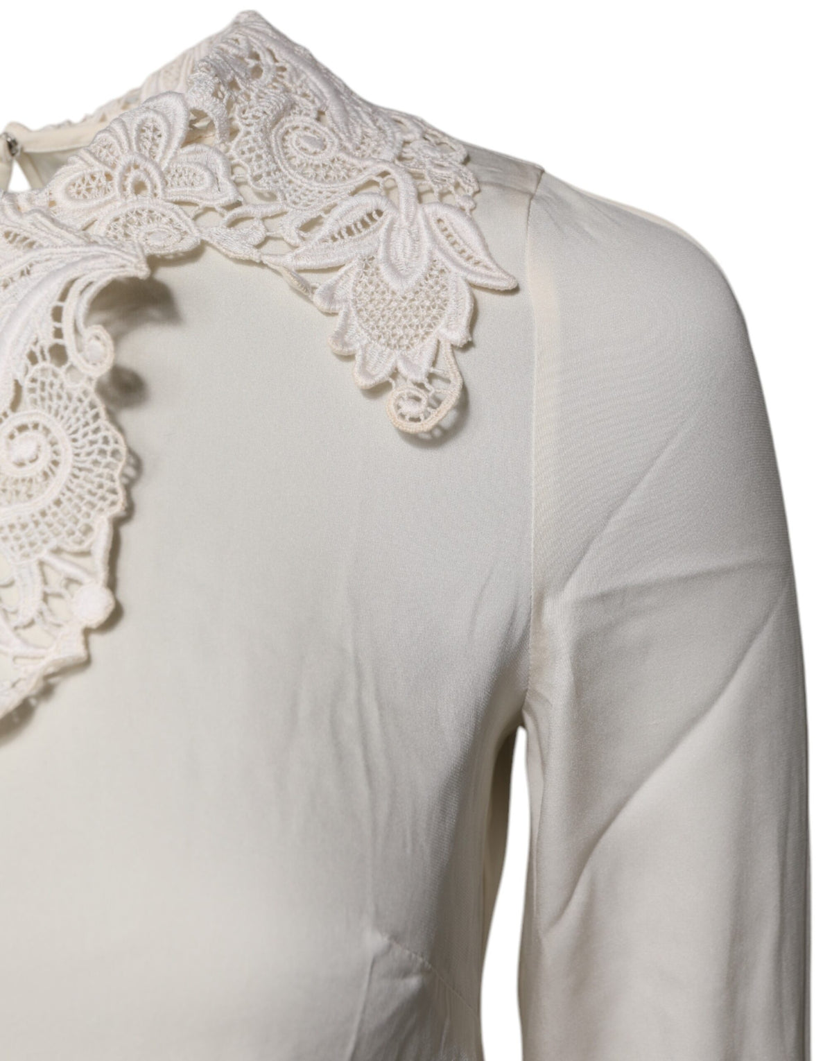 Indulge in the exquisite Dolce & Gabbana Cream Floral Lace Long Sleeves Blouse, a masterpiece of silk and lace that embodies timeless elegance and sophisticated allure.