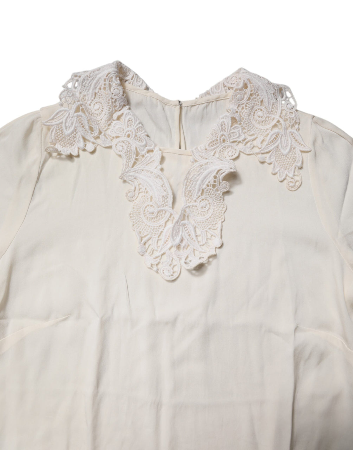 Indulge in the exquisite Dolce & Gabbana Cream Floral Lace Long Sleeves Blouse, a masterpiece of silk and lace that embodies timeless elegance and refined luxury.