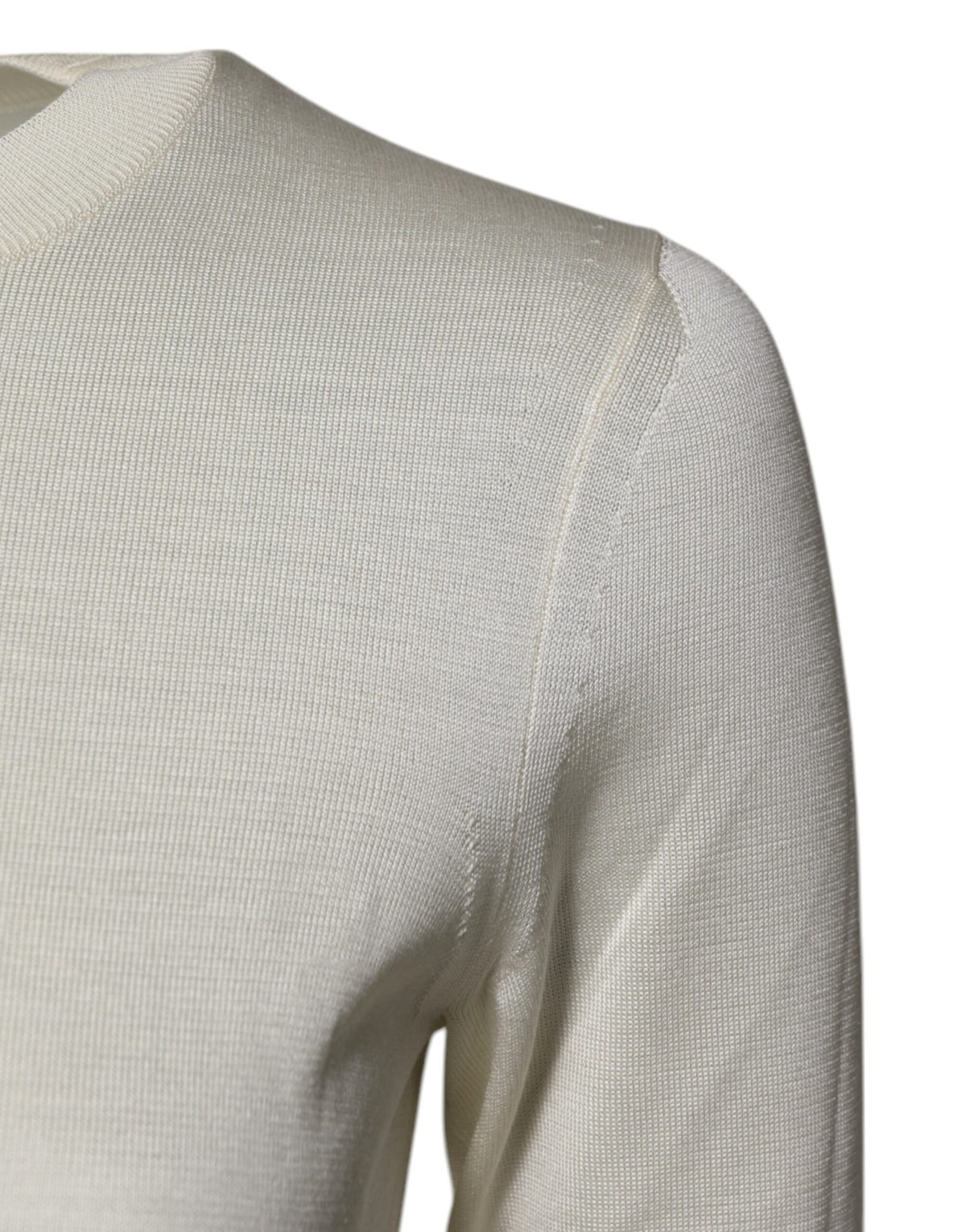 Experience the allure of Dolce & Gabbana's Cream Silk Blouse, a testament to Italian craftsmanship that embodies timeless elegance and sophisticated luxury.