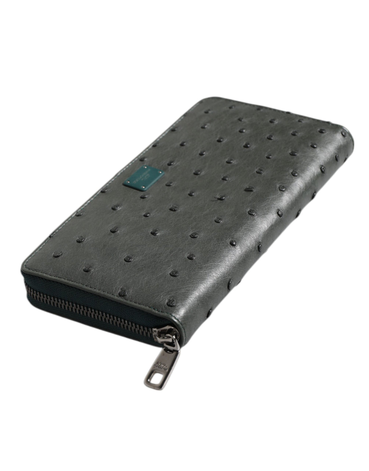 Discover the Dolce & Gabbana Green Ostrich Logo Plaque Zip Around Continental Wallet, a masterpiece of exquisite craftsmanship in luxurious ostrich leather, perfect for the discerning individual.