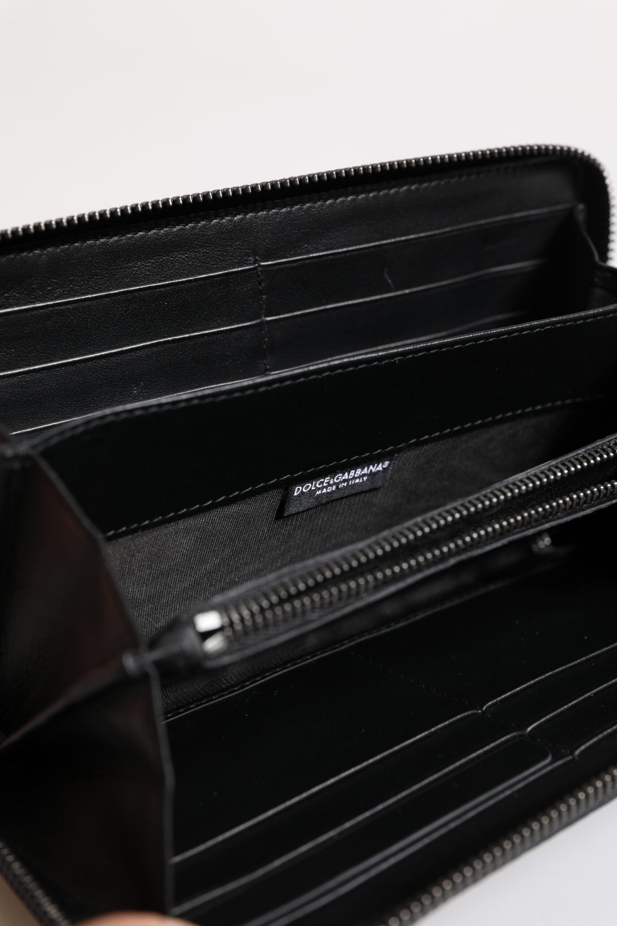 Indulge in the exquisite Dolce & Gabbana Black Blue Exotic Leather Embossed Continental Wallet, a luxurious blend of calfskin and land snake, crafted for the discerning individual.