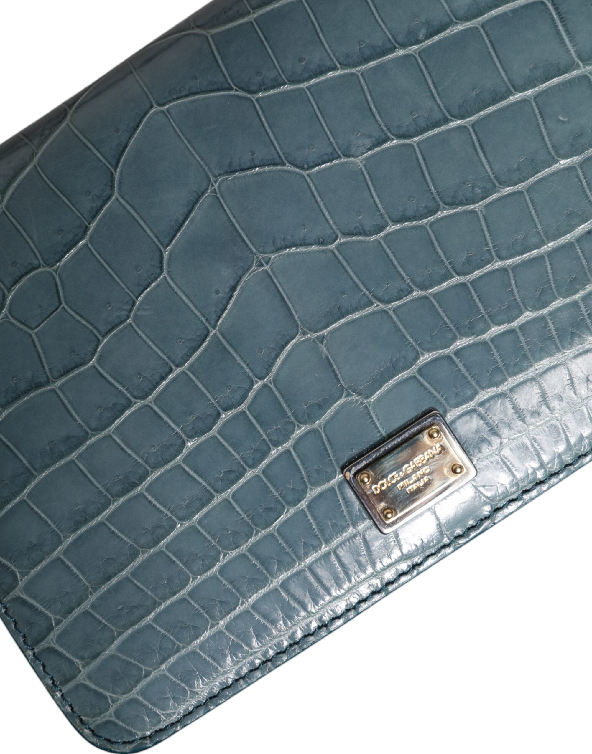 Elevate your style with the Dolce & Gabbana Green Exotic Leather DG Plaque Crossbody Mini Bag, a luxurious blend of crocodile and calf leather, crafted for the discerning individual.